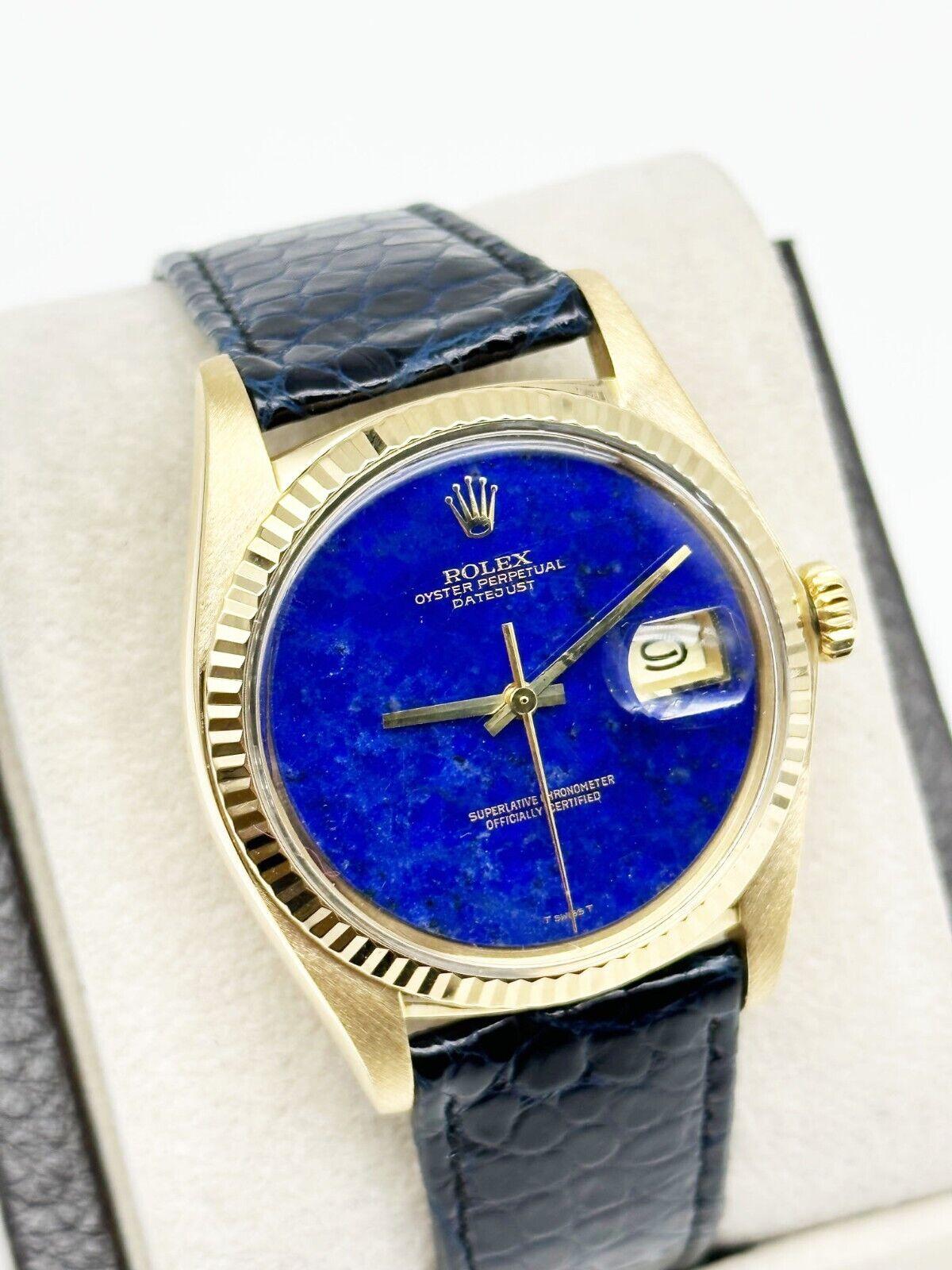 Style Number: 1601

 

Serial: 6061***

Year: 1978 

Model: Datejust 

Case Material: 18K Yellow Gold 

Band: Navy Blue Leather Strap with Custom Clasp 

Bezel: 18K Yellow Gold 

Dial: Custom Lapis Lazuli Dial 

Face: Acrylic Crystal 

Case Size: