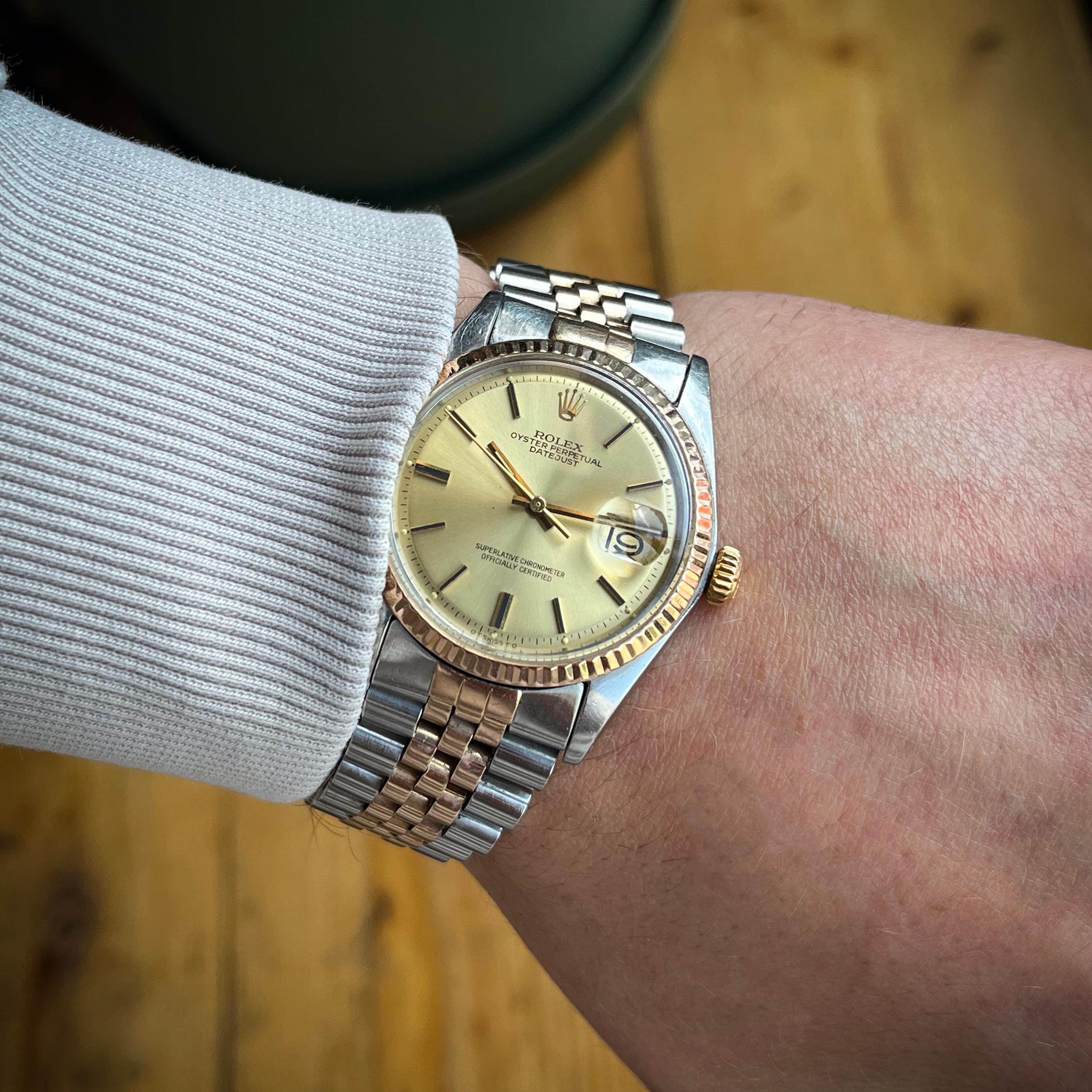 An elegant vintage Rolex DateJust, reference 1601, featuring a 36mm stainless steel case with an 18kt rose gold fluted bezel and matching Jubilee bracelet. The watch showcases a classic champagne pie-pan dial with baton indices and date display at 3