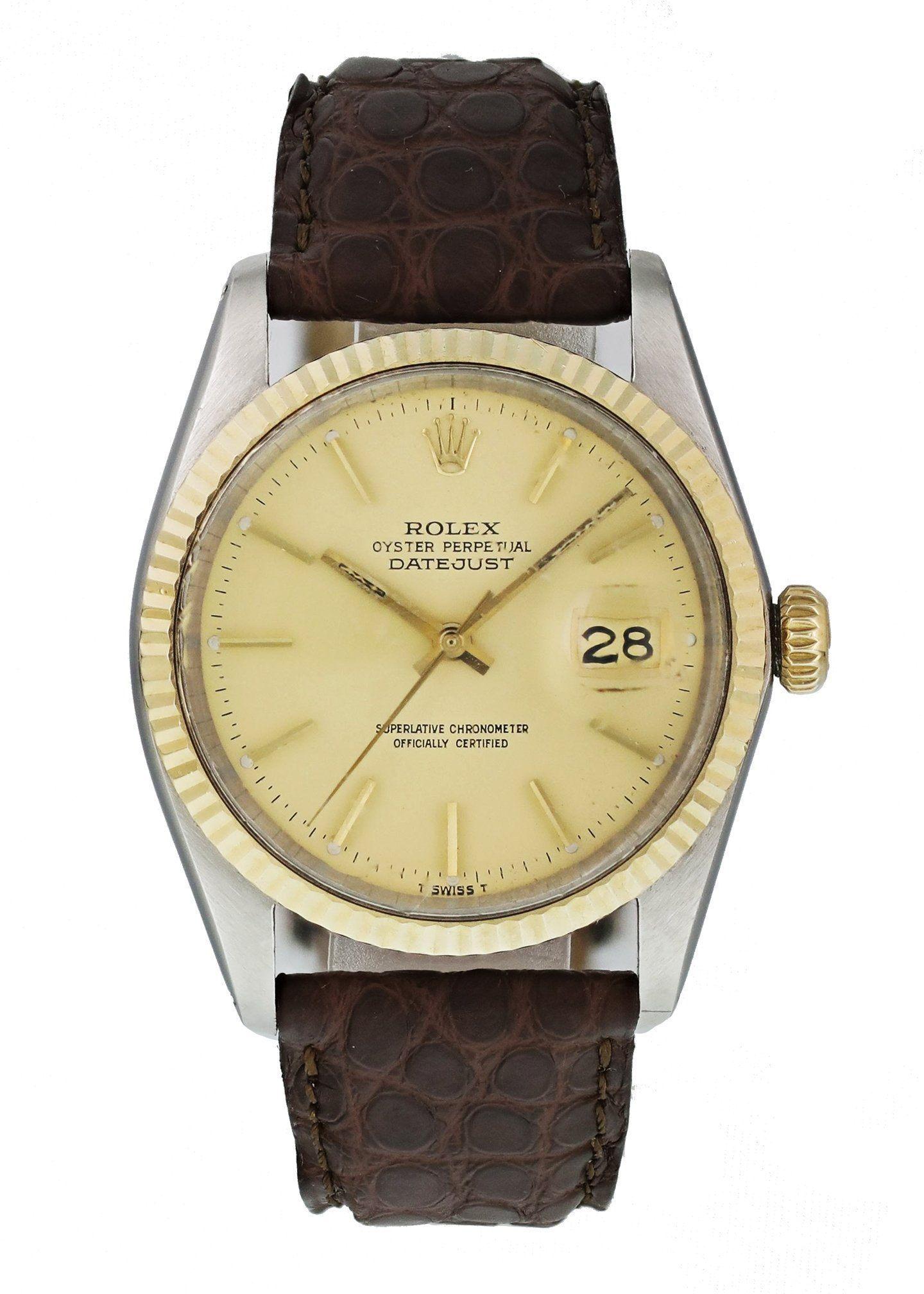 Rolex Datejust 16013 Men's Watch. 
36mm Stainless Steel case. 
Yellow Gold fluted bezel. 
Champagne dial with gold hands and index hour markers. 
Minute markers on the outer dial. 
Date display at the 3 o'clock position. 
Leather Strap with Tang