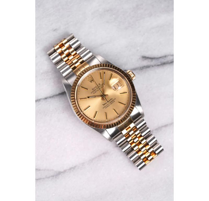 Here's a vintage Rolex Datejust reference 16013 automatic in 18K yellow gold with a rare champagne Tiffany & Co stamped dial from the 1980s. Keeps great time and is fully functional. Measurements include a 36mm oyster case and 20mm lug width. It's
