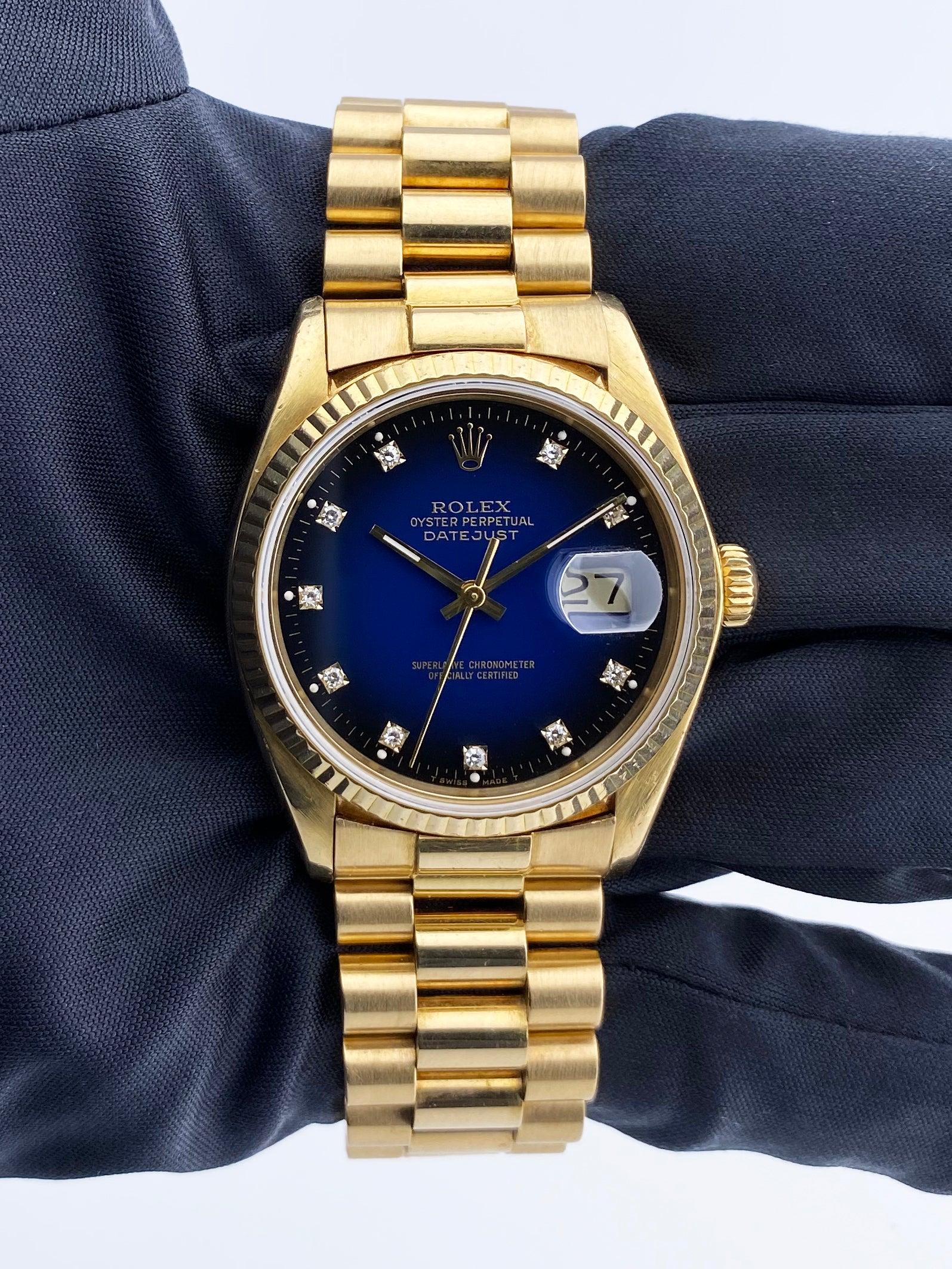 Rolex Datejust 16018 Mens Watch. 36mm 18K yellow gold case. 18K yellow gold fluted bezel. Blue vignette dial with gold hands and original factory diamond set hour markers. Minute markers on the outer dial. Date display at the 3 o'clock position. 18k
