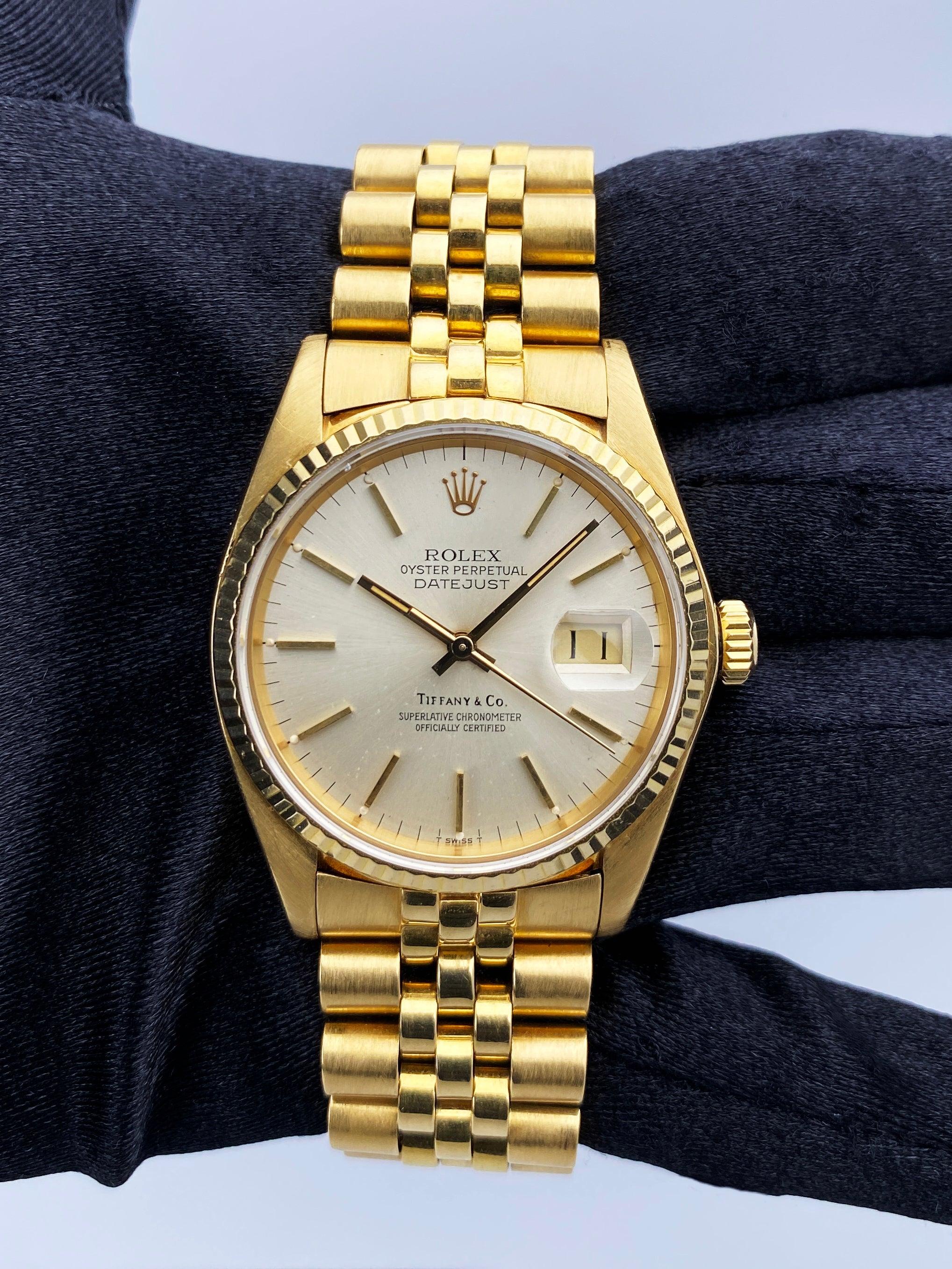 Rolex Datejust 16018 Mens Watch. 36mm 18K yellow gold case. 18K yellow gold fluted bezel. Tiffany & Co. dial with gold hands and index hour markers. Minute markers on the outer dial. Date display at the 3 o'clock position. 18k yellow gold