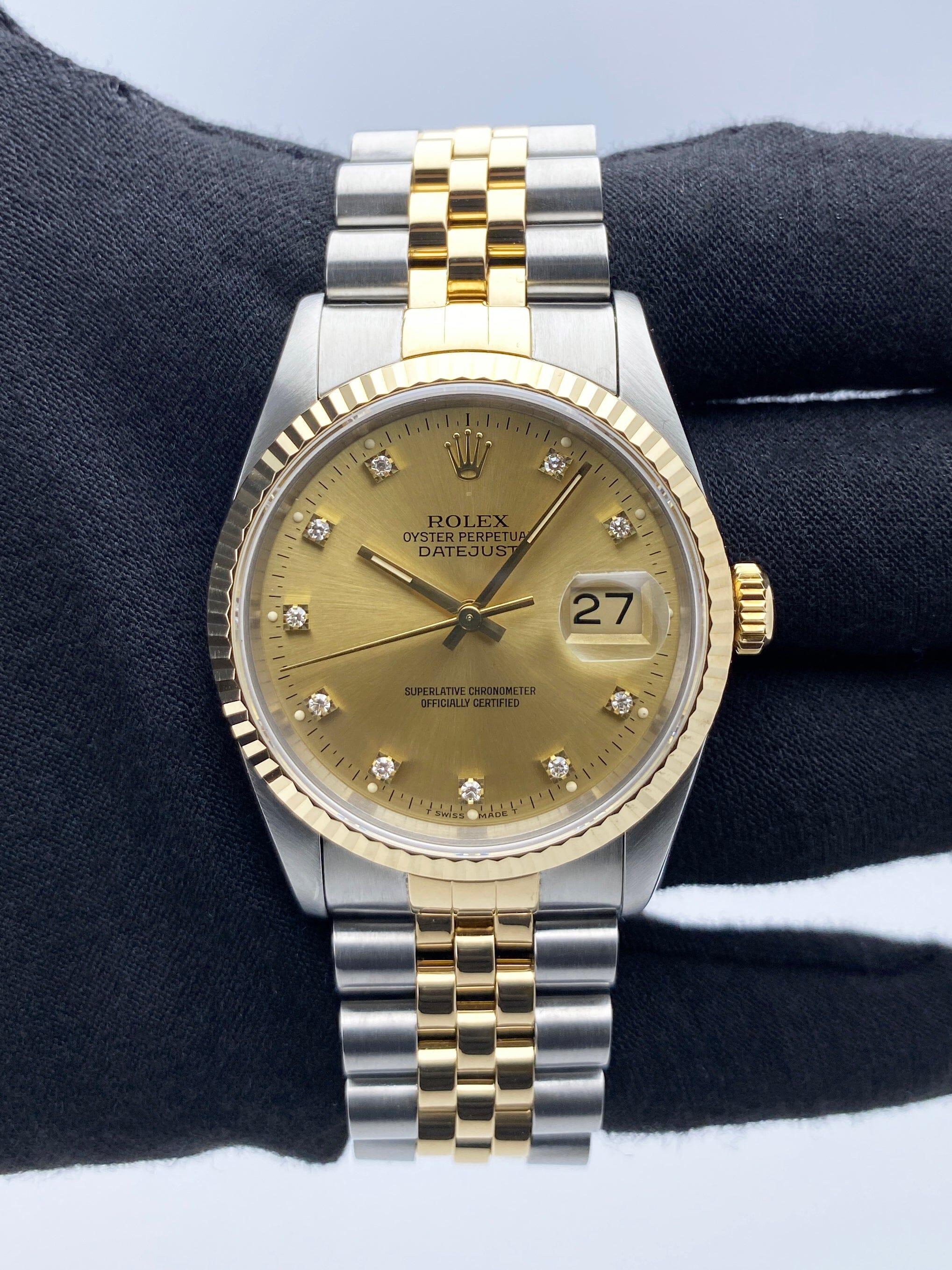 Rolex Datejust 16233 Mens Watch. 36mm Stainless steel case. 18K yellow gold fluted bezel. Champagne dial with gold hands and factory diamond hour markers. Minute markers on the outer dial. Date display at the 3 o'clock position. Stainless