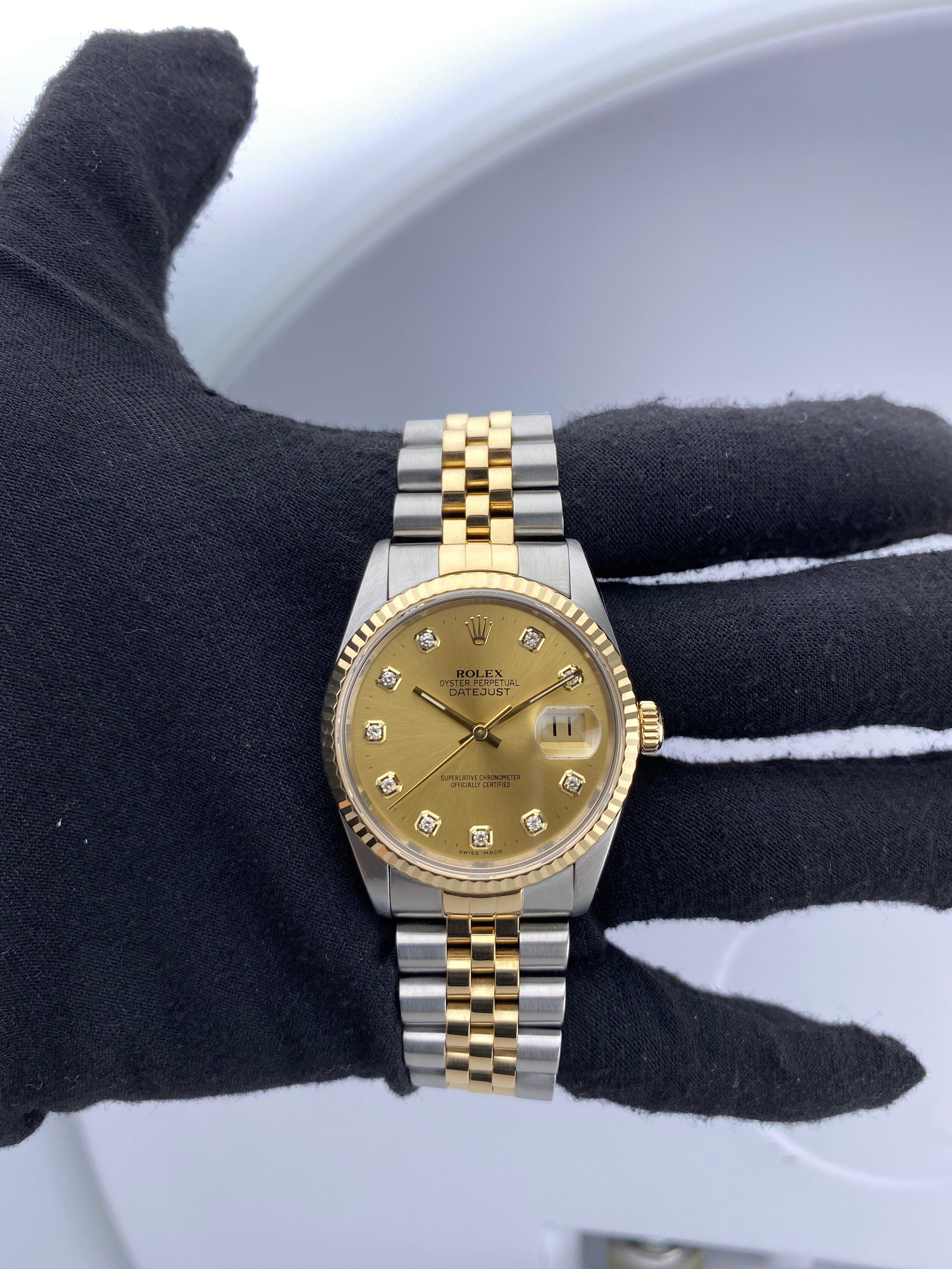 Reloj Rolex Datejust 16233 para caballero. Caja de acero inoxidable de 36 mm. Bisel estriado de oro amarillo de 18 quilates. Esfera de color champán con agujas doradas e índices engastados con diamantes originales de fábrica. Marcadores de minutos