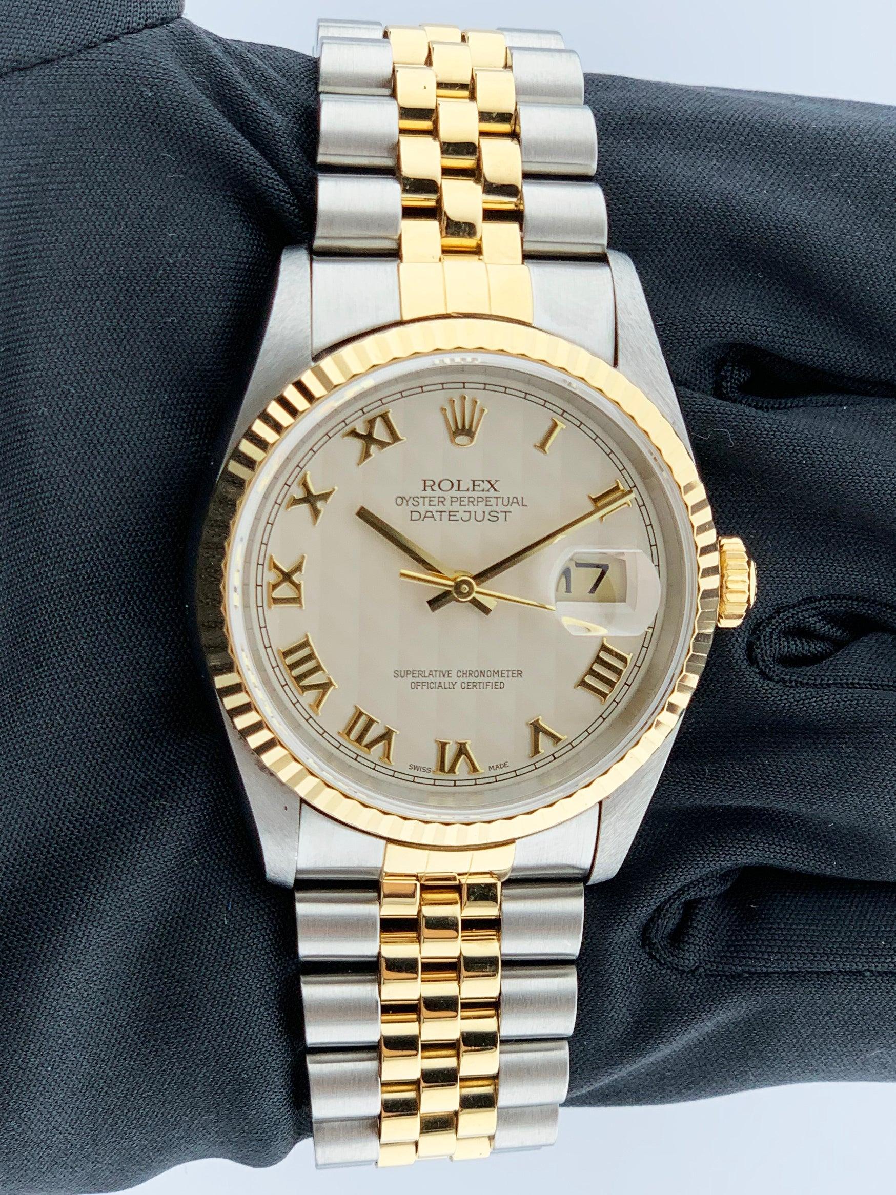 Rolex Oyster Perpetual Datejust 16233 Mens Watch. 36mm Stainless Steel case with  18K Yellow Gold fluted bezel. Ivory pyramid dial with gold hands and gold Roman numeral hour markers. Minute markers on the outer dial. Date display at the 3 o'clock