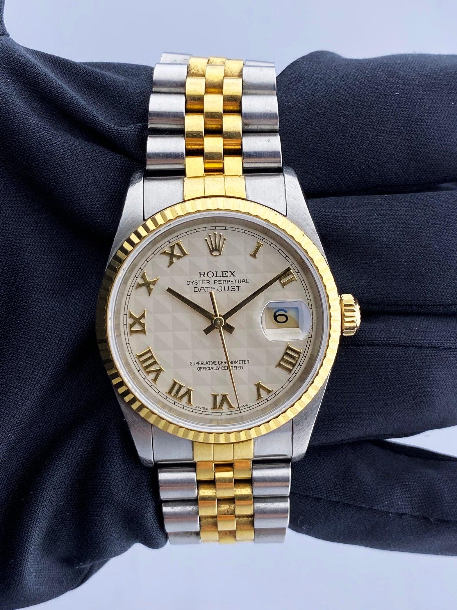 Rolex Oyster Perpetual Datejust 16233 Mens Watch. 36mm stainless steel case with  18K yellow gold fluted bezel. Ivory pyramid dial with gold hands and gold Roman numeral hour markers. Minute markers on the outer dial. Date display at the 3 o'clock