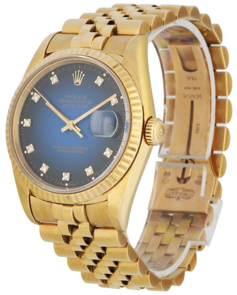 Rolex Datejust 16238 Men Watch. 36mm 18k Yellow Gold case. 18K Yellow Gold fluted bezel. Blue vignette dial with gold hands and diamond hour markers. Minute markers on the outer dial. Date display at the 3 o'clock position. 18K Yellow Gold jubilee