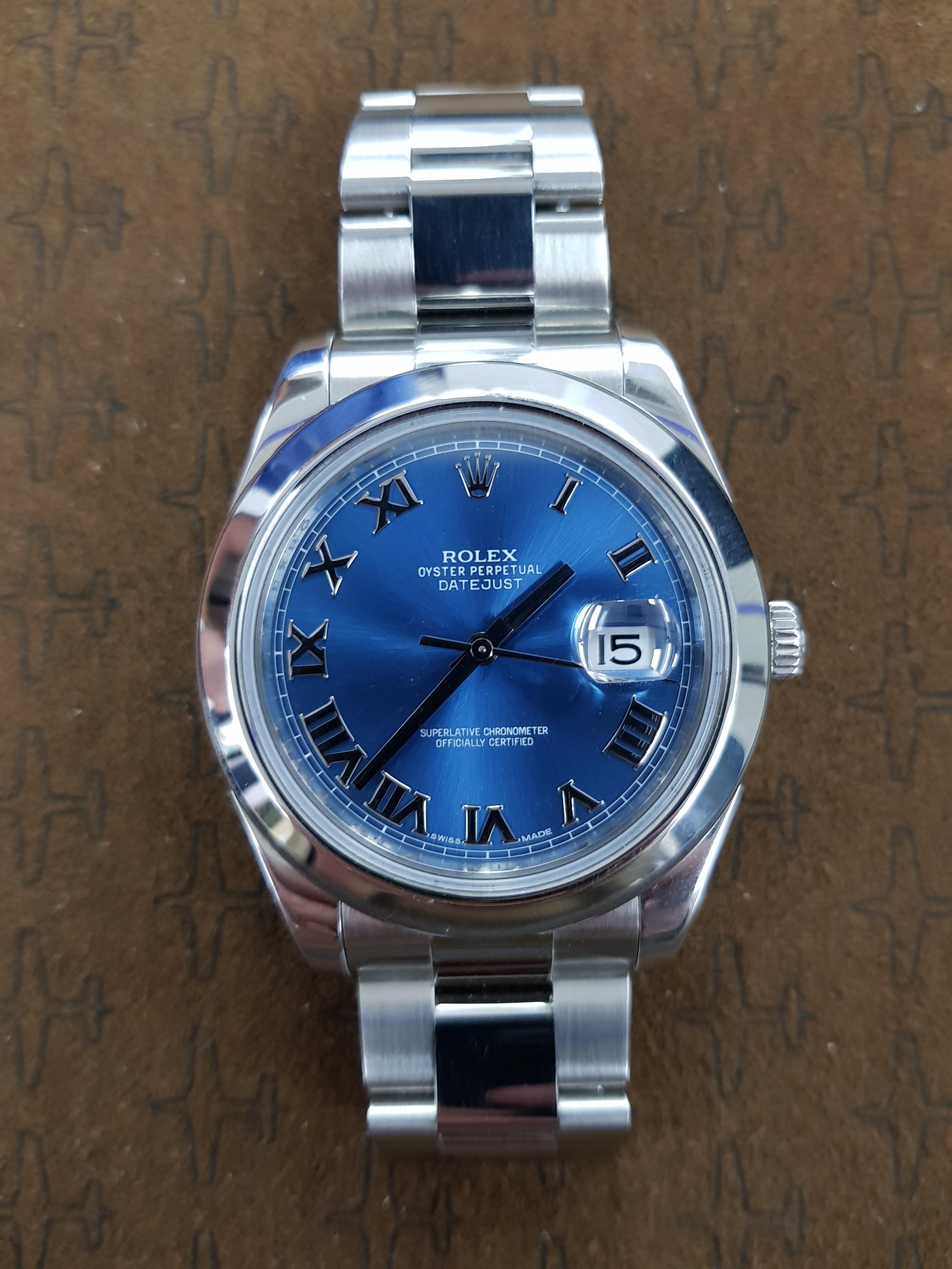 Rolex Date Just 2 in stainless steel with a 41 mm blue dial. This watch comes with full Rolex certification.