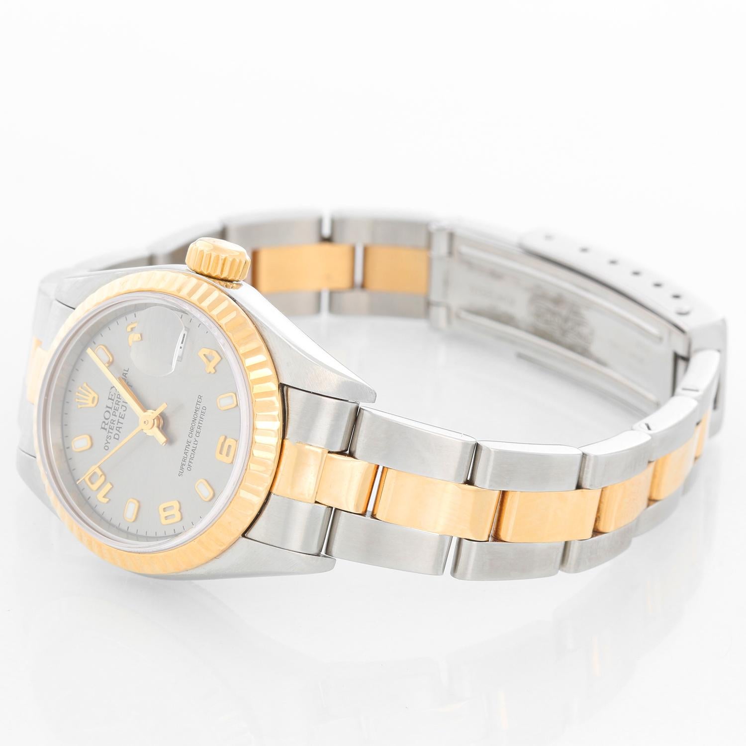 Rolex Datejust 2-Tone Ladies Steel & Gold Watch 79173 - Automatic winding, Quickset, 31 jewels, sapphire crystal. Stainless steel case with 18k yellow gold fluted bezel (26mm diameter). Gray dial with Arabic numerals and luminous markers. Stainless