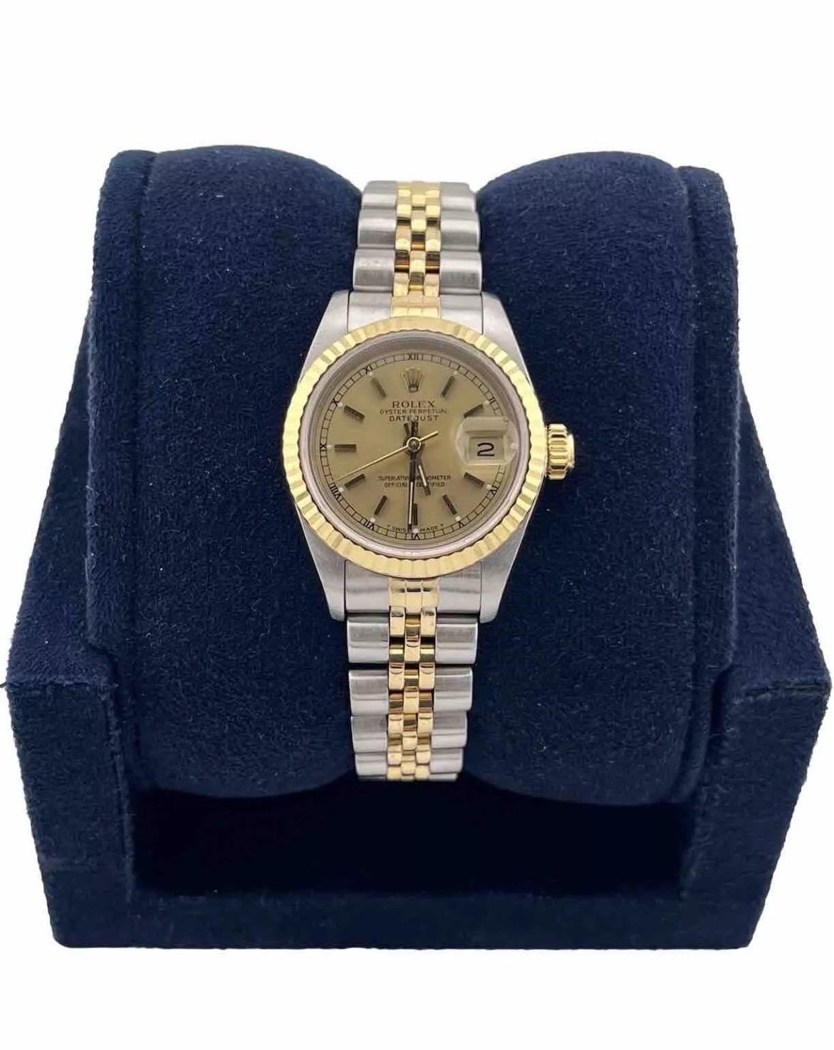 The Rolex Datejust 26mm Champagne Dial 18K Yellow Gold & Steel Two-Tone Watch 69173 with a Jubilee band epitomizes timeless sophistication and exceptional craftsmanship. The 26mm case, combining durable stainless steel with luxurious 18K yellow