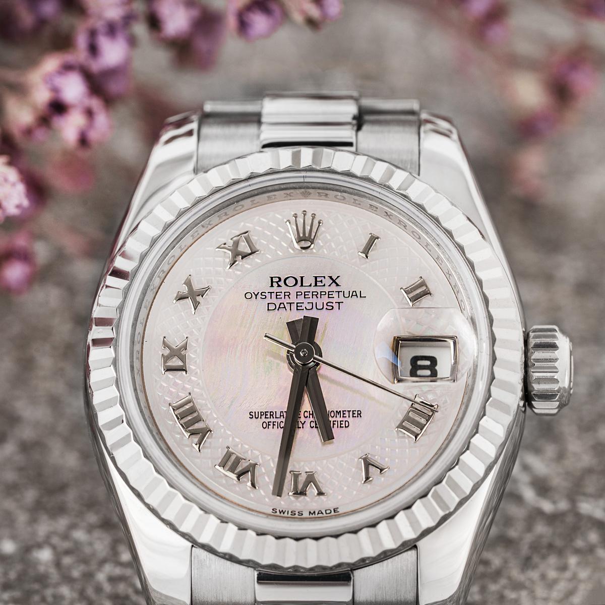 A 26mm white gold ladies Datejust by Rolex. Featuring a stunning mother of pearl dial with applied roman numerals and a white gold fluted bezel. Fitted with a sapphire glass, a self-winding automatic movement and a white gold president bracelet