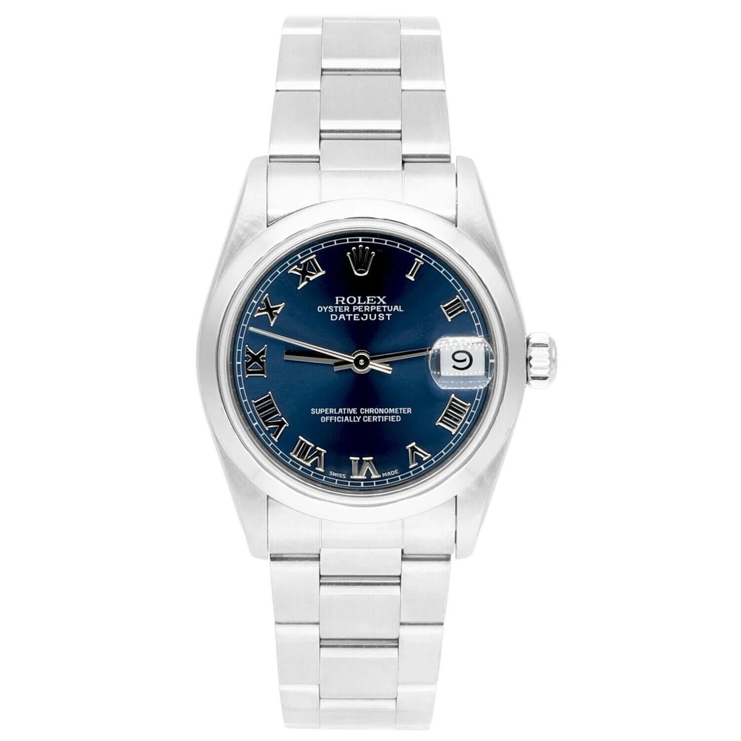 Silver-tone stainless steel case with a silver-tone stainless steel oyster bracelet. Fixed fluted silver-tone 18k white gold bezel. Blue dial with silver-tone hands and Roman numeral hour markers. Minute markers around the outer rim. Dial Type: