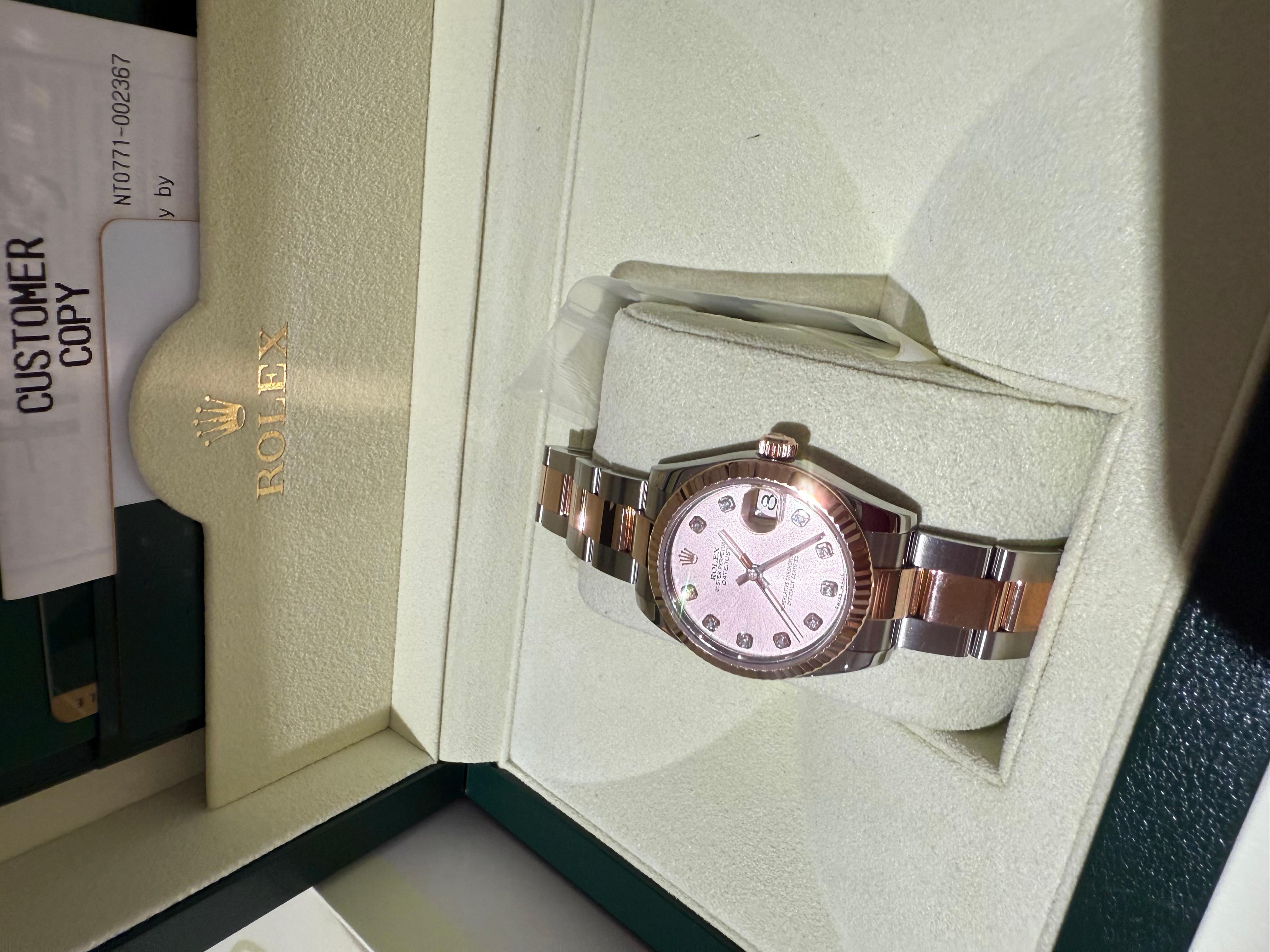 Rolex Datejust 31 Sundust Pink Diamond Dial Two Tone Rose Gold Fluted Bezel Jubilee watch. 
10 Diamonds Set on Dial, Solid 18k Everose Gold Fluted Bezel. With original box authenticity card, tags and spare links. Recently fully services by Rolex