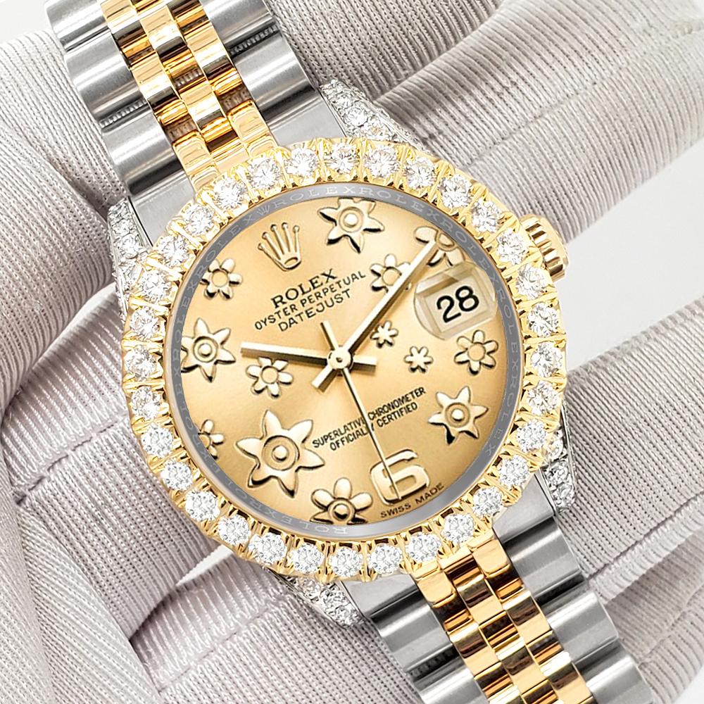 ElegantSwiss a le plaisir de vous proposer cette montre Rolex Datejust midsize 31mm 2-Tone champagne floral avec lunette/case en diamant de 4,4ct (les diamants ne sont pas sertis par Rolex) en or jaune et acier inoxydable jubilé, Ref