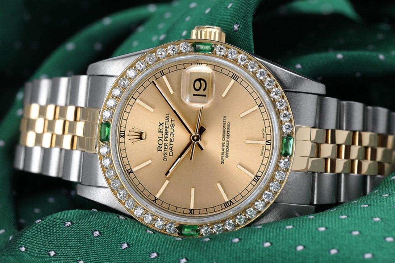 Rolex Datejust 31mm Champagne Dial Diamond & Emerald Bezel 18k Gold/Steel Watch
The watch is in impeccable condition, having undergone professional polishing and servicing to ensure its pristine appearance. This watch has been customized with