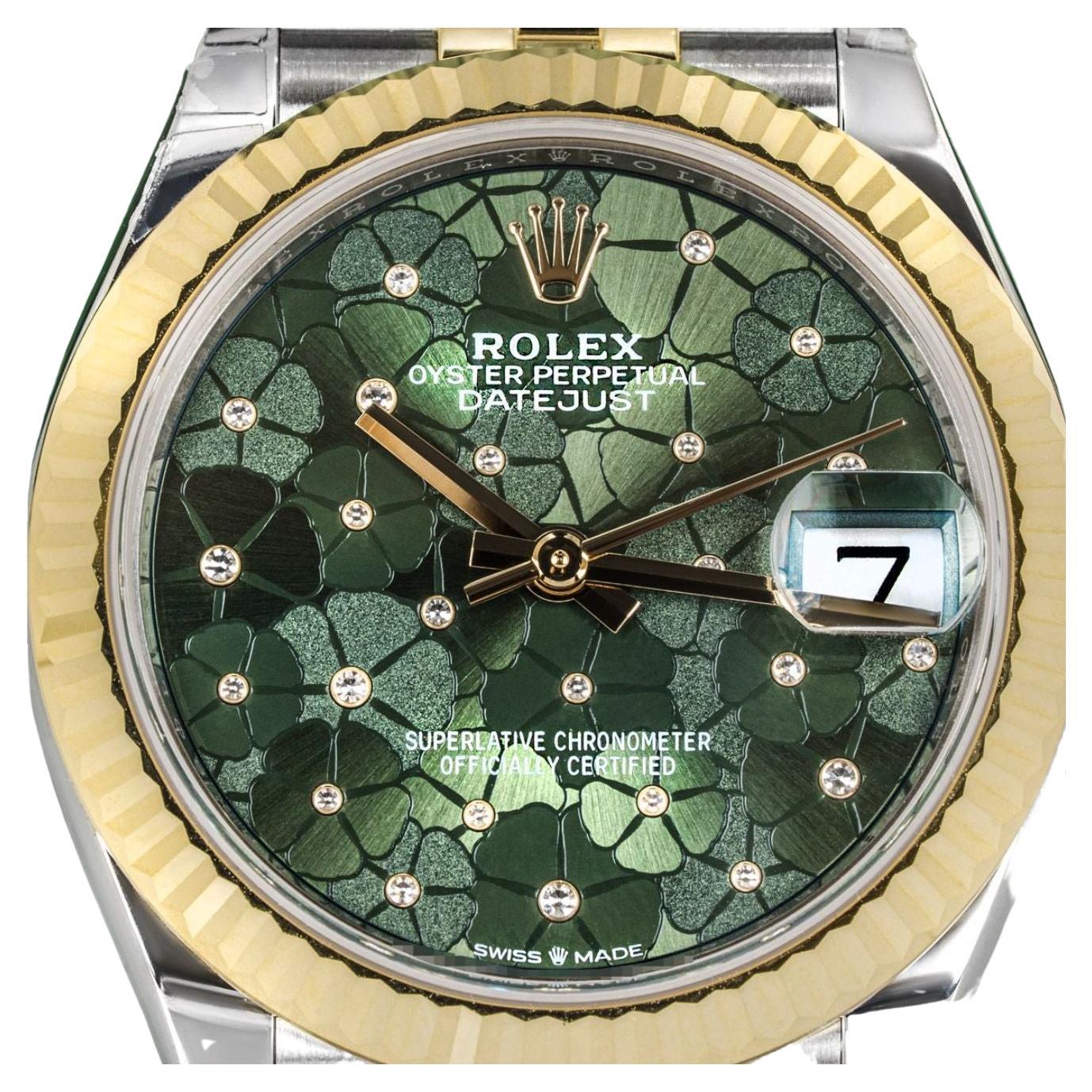 A stainless steel and yellow gold 31mm Datejust by Rolex. Featuring a green floral motif diamond-set dial and a yellow gold fluted bezel. The Jubilee bracelet is equipped with a concealed folding Crownclasp. Fitted with a scratch-resistant sapphire