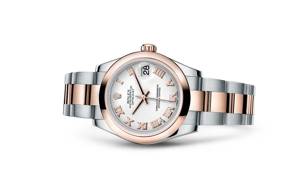 Polished stainless steel case.
Polished 18kt Pink Gold crown.
Polished 18kt Pink Gold domed bezel.
White dial.
Applied polished pink gold toned Roman Numeral hour markers.
Polished pink gold toned hands.
Date window displayed at the 3 o'clock