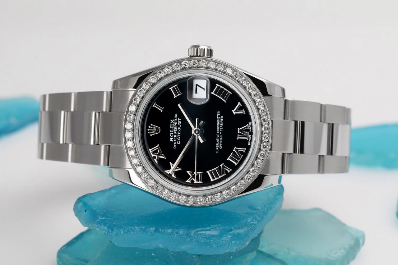 Rolex Datejust 31mm Stainless Steel Ladies Watch with Black Roman Dial and Diamond Bezel 178240

Genuine Rolex Datejust 31mm Stainless Steel with factory dial and custom diamond bezel. It has been polished, serviced and there are absolutely NO