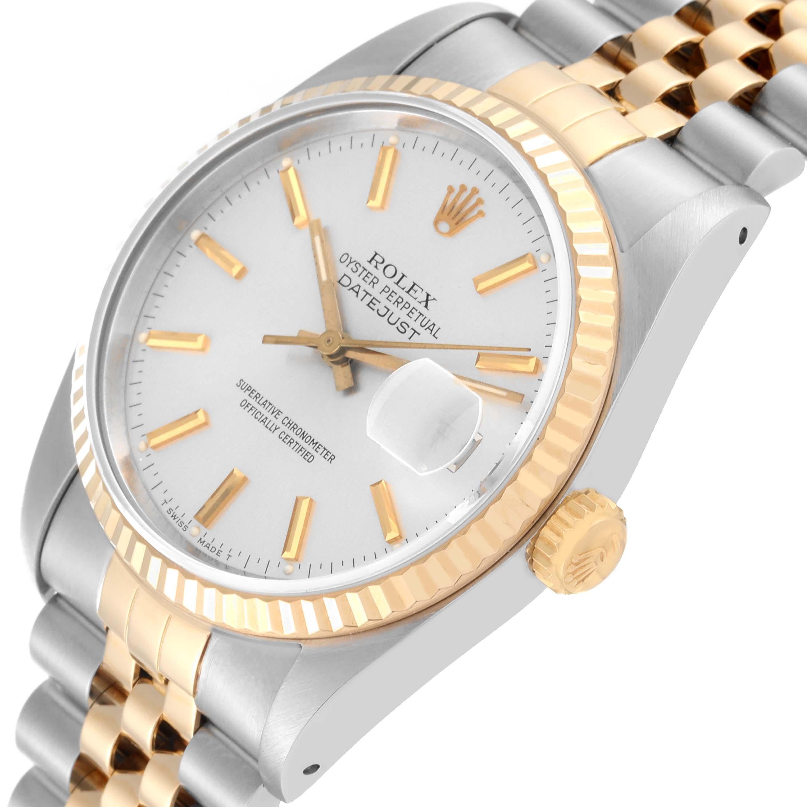 Rolex Datejust 36 Steel Yellow Gold Silver Dial Mens Watch 16233 Box Papers. Officially certified chronometer automatic self-winding movement. Stainless steel case 36 mm in diameter.  Rolex logo on an 18K yellow gold crown. 18k yellow gold fluted