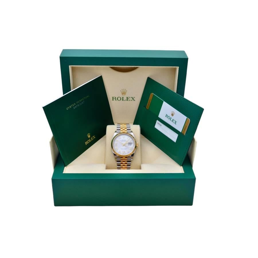 The Rolex Datejust 36 Two Tone with a Silver Diamond Dial and Full Set from 2019, referenced as 126233, is a prestigious and stylish wristwatch known for its timeless design and precision.  This watch has a 36mm case size, making it a versatile and