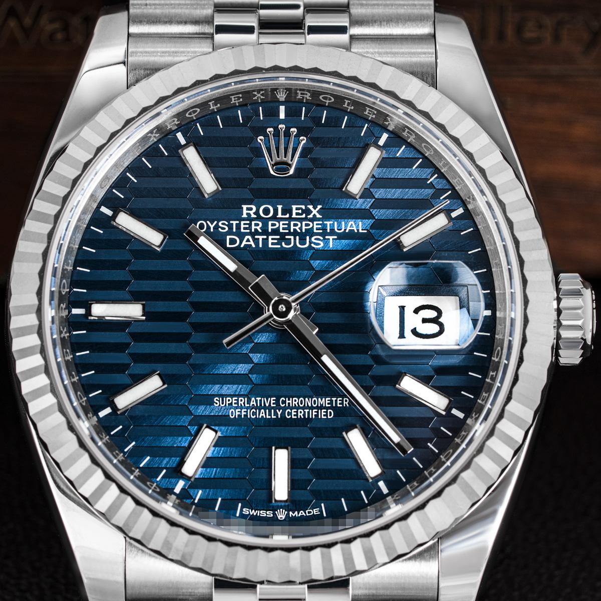 An unworn 36mm Datejust in stainless steel by Rolex. Features a blue fluted motif dial with applied hour markers and a fluted white gold bezel. Equipped with a stainless steel Jubilee bracelet and a steel folding clasp. The watch is also fitted with