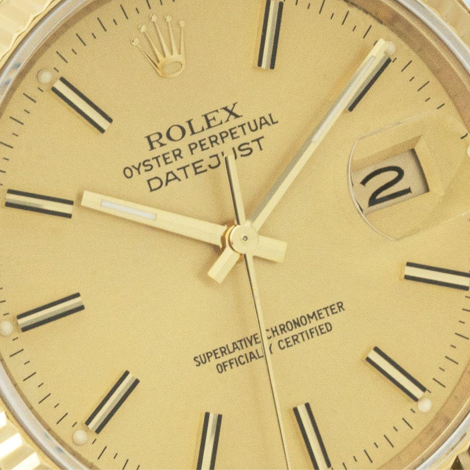 A 36mm Datejust in yellow gold. Featuring a champagne dial with applied hour markers and a fluted yellow gold bezel. The watch is fitted with a sapphire glass, a self-winding automatic movement and a generic brown leather strap equipped with an