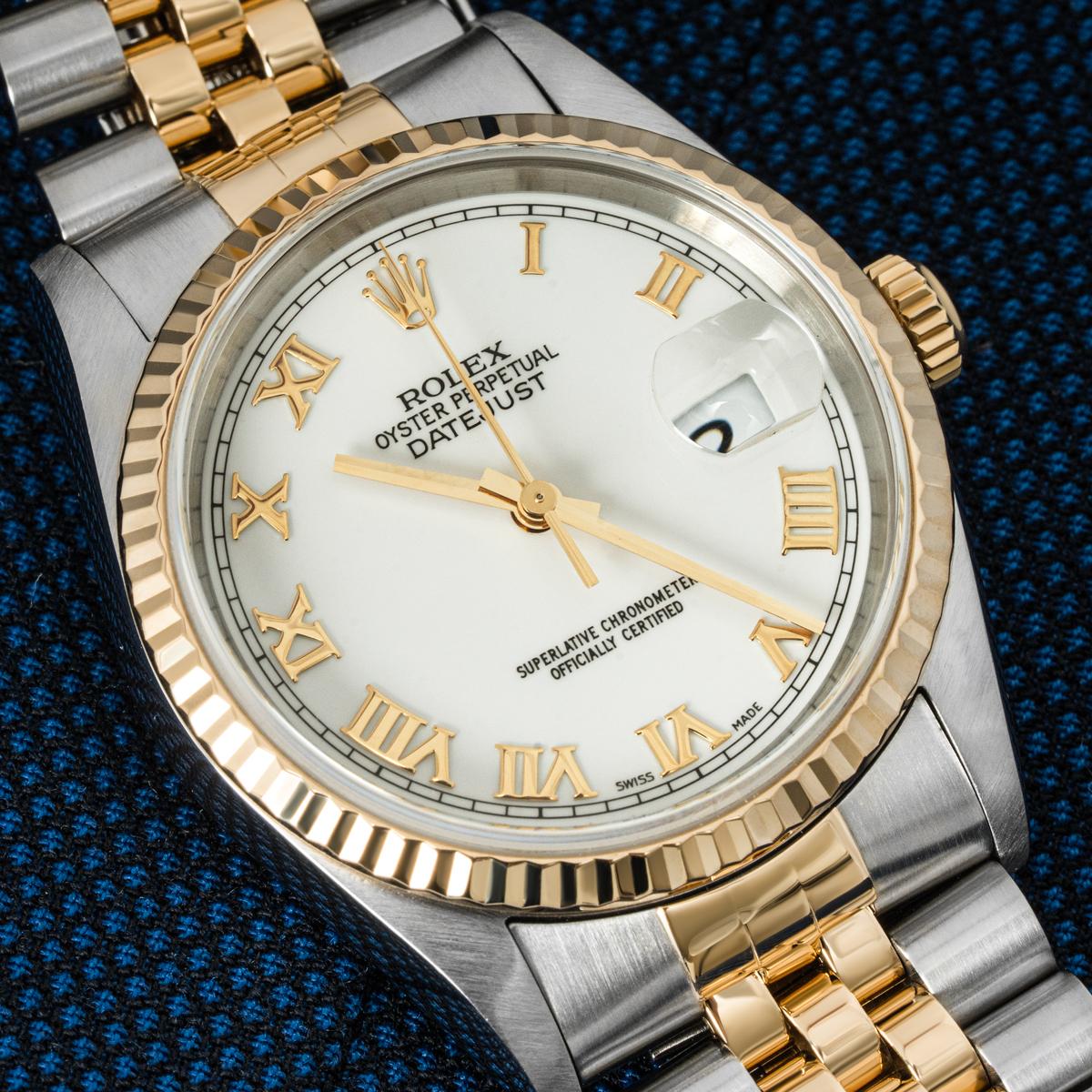 A 36mm stainless steel and yellow gold Datejust by Rolex. Featuring a white dial with applied roman numerals and a yellow gold fluted bezel. Fitted with a sapphire crystal, a self-winding automatic movement and a steel and gold Jubilee bracelet