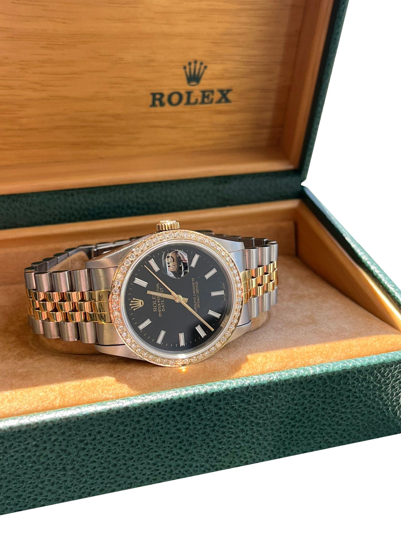 Rolex Datejust Steel Yellow Gold Black Dial with Custom Aftermarket Diamond Bezel Mens Watch 16233. Officially certified chronometer self-winding movement. Stainless steel case 36 mm in diameter. Rolex logo on an 18K yellow gold crown. 18k yellow