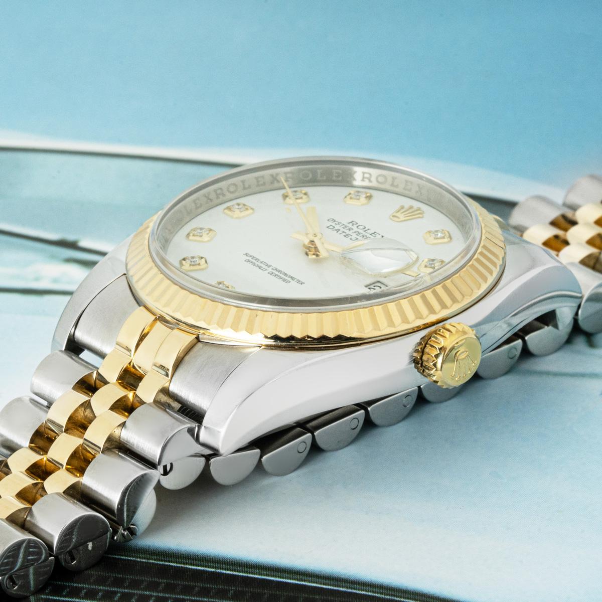 A steel and gold Datejust by Rolex. Featuring a white dial with diamond set hour markers and a yellow gold fluted bezel. Fitted with a sapphire crystal, a self-winding automatic movement and a steel and gold jubilee bracelet equipped with a