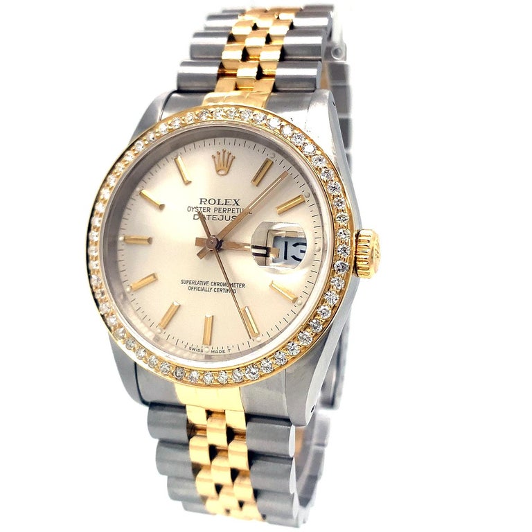 Rolex Datejust (16233) self-winding automatic watch features a 36mm stainless steel case with a diamond bezel surrounding a silver dial on stainless steel and an 18k yellow gold Jubilee bracelet with a folding buckle. Functions include hours minutes