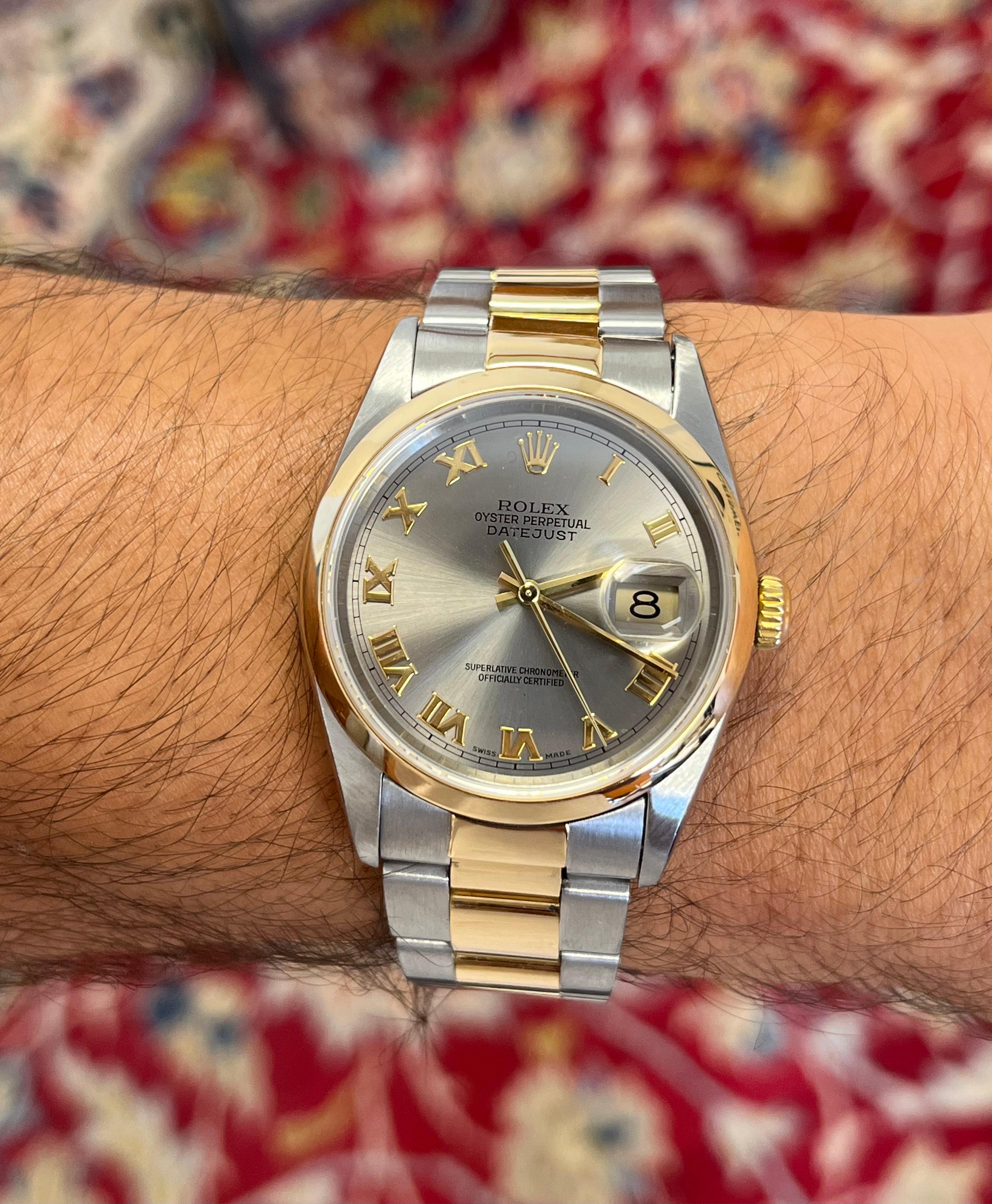 Rolex Datejust 36mm 16203 with Gray and Gold roman numeral dial. Two-tone Oyster bracelet with deployment clasp. A chic and classic Rolex with the aesthetic and structural versatility to be worn for dressy and casual wear.

Adjustable Oyster