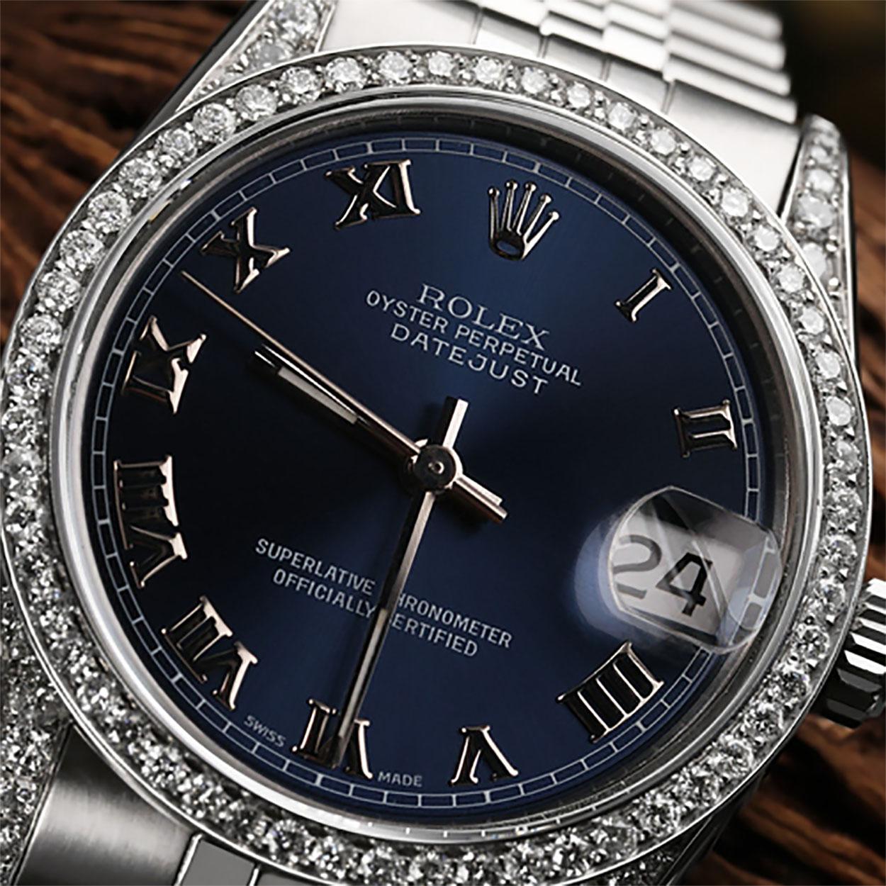 Rolex Datejust 36mm Navy Roman Dial Diamond Bezel & Lugs Stainless Steel Watch.
This watch features aftermarket diamonds (non-Rolex) and is in excellent, like-new condition with no visible scratches or imperfections. Our watches are backed by a