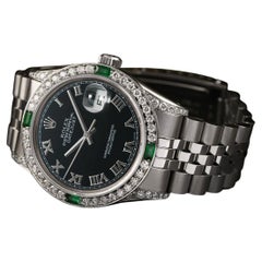Rolex Montre Datejust en acier inoxydable avec cadran romain noir et lunette en diamants et émeraudes