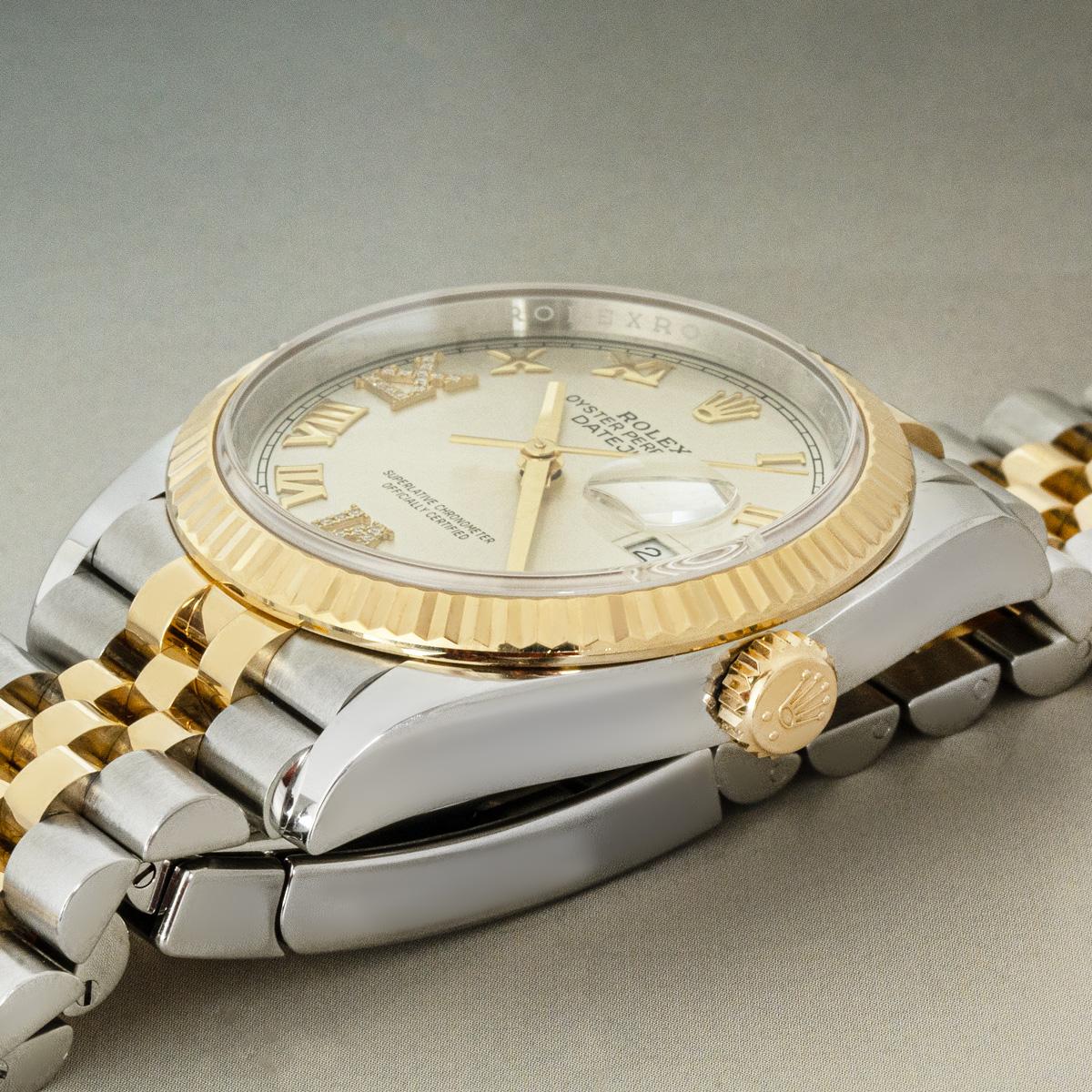 A 36mm Oystersteel and yellow gold Datejust by Rolex. Features a silver dial with diamond set Roman numerals VI & IX. Fitted with sapphire crystal and a self-winding automatic movement. The watch is equipped with a Jubilee bracelet set that has an