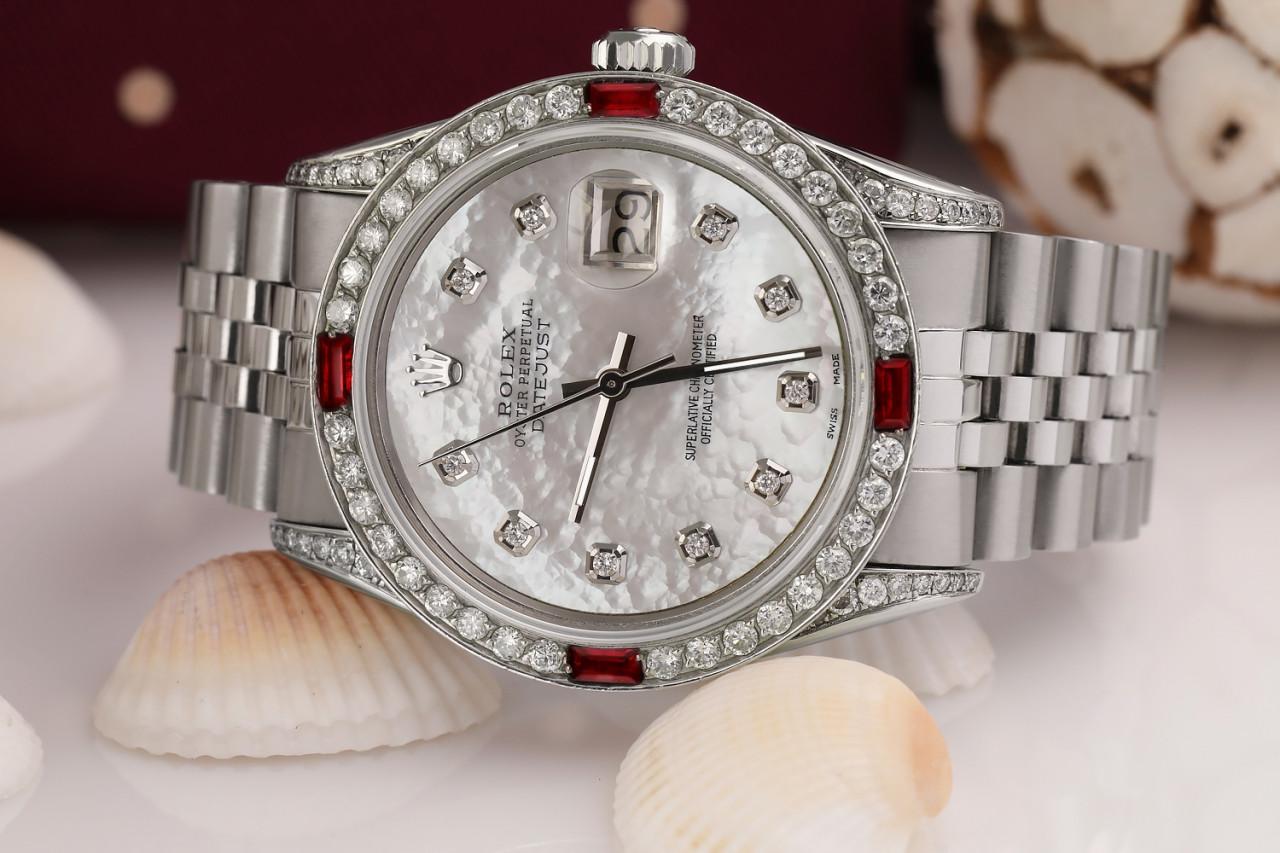 Rolex Datejust 36mm White Mother of Pearl Dial Diamond Numbers with Ruby & Diamond Bezel Jubilee Band 16014

This watch is in like new condition. It has been polished, serviced and has no visible scratches or blemishes. All our watches come with a