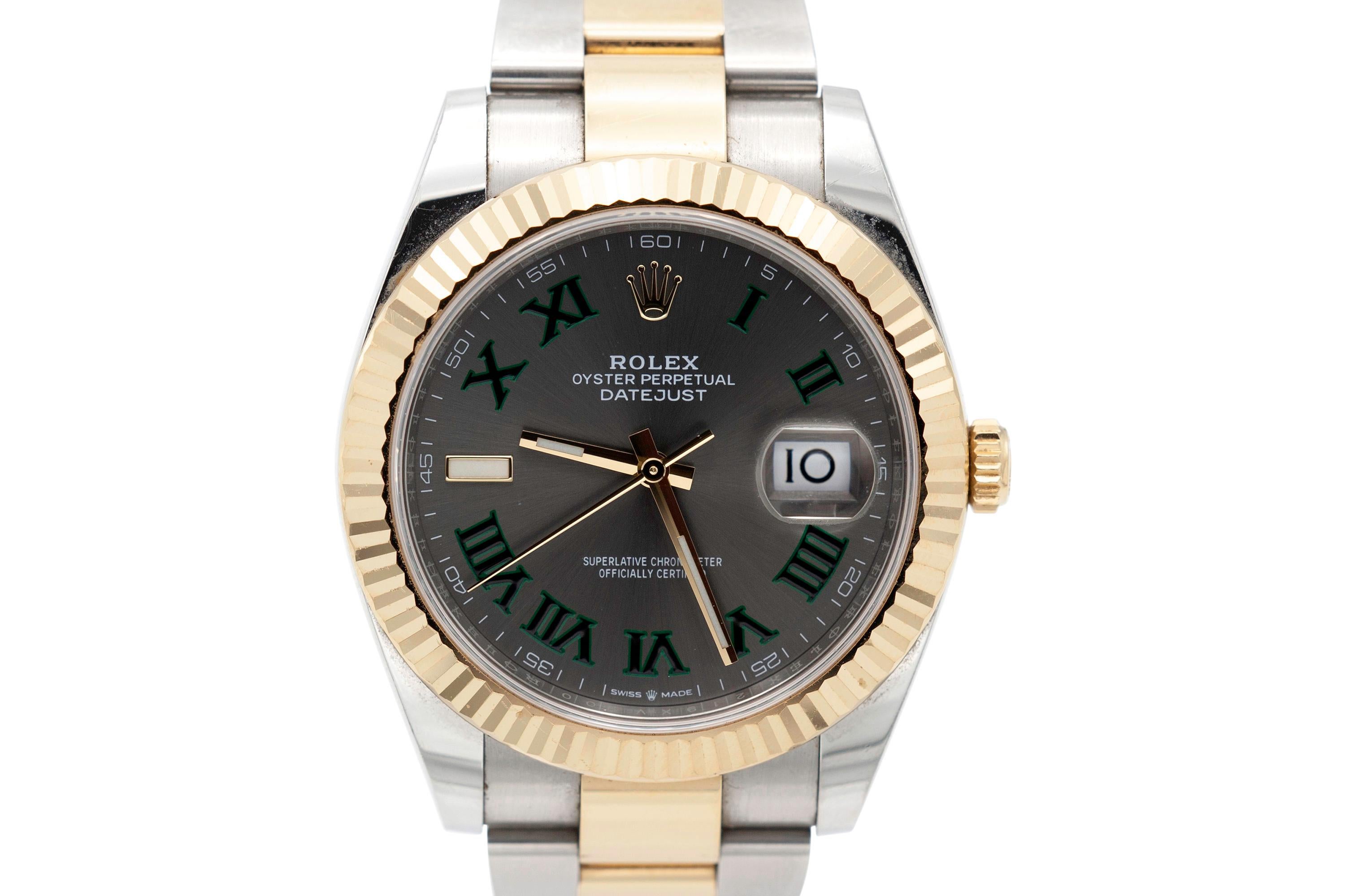 Rolex Oyster Perpetual Datejust men's watch crafted in stainless steel and 18K yellow gold with a 41mm wimbledon roman dial, fluted bezel and oyster band.
Comes with certification (pictured). 
Model 126333. Serial No. 219xv100.