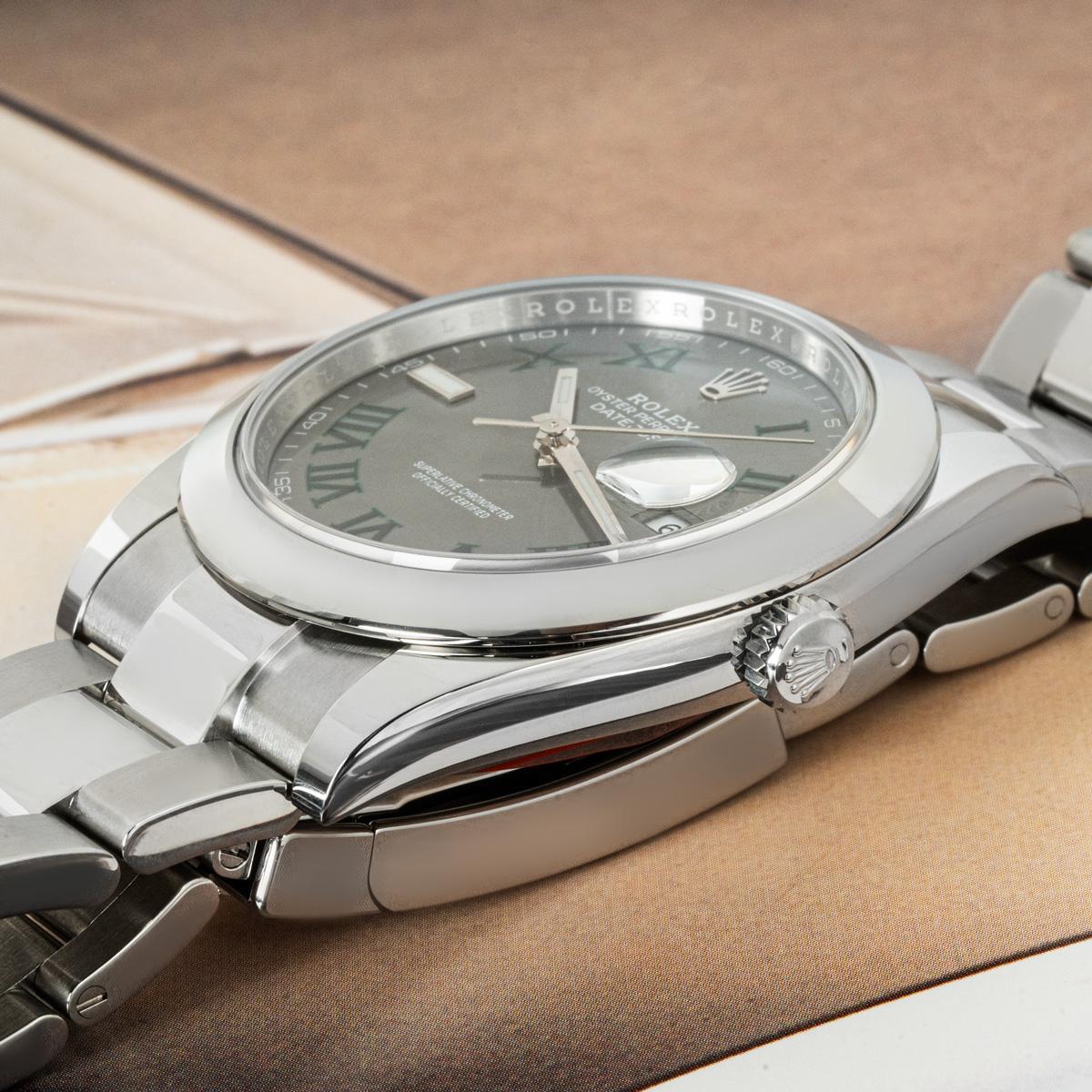 An unworn 41mm Datejust from Rolex in Oystersteel. Features a Wimbledon dial with Roman numerals and a smooth bezel. The Oyster bracelet comes an Oyster deployant clasp which is equipped with the Easylink 5mm comfort extension link. Fitted with a