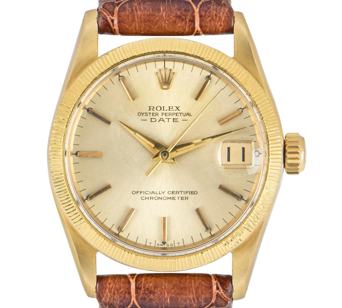A Rolex midsize Date in yellow gold. Featuring a champagne dial with applied hour markers, a date aperture and a fixed yellow gold bezel. The watch is fitted with a plastic glass, a self-winding automatic movement and is presented on a generic brown
