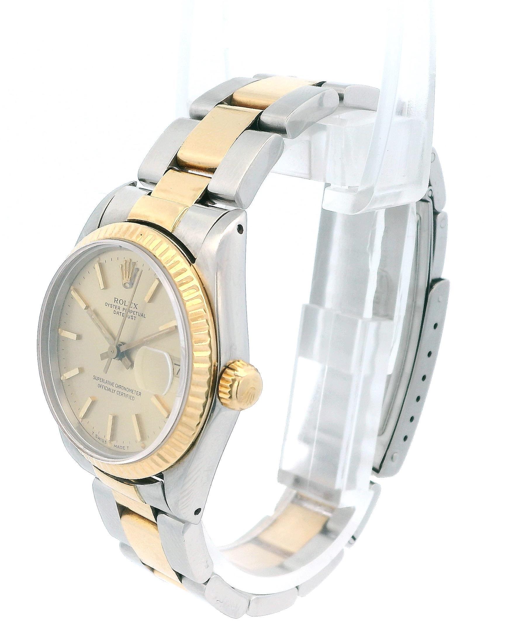 Rolex Datejust 68273 Damenuhr. Dieser Zeitmesser verfügt über ein 31-mm-Edelstahlgehäuse und eine geriffelte Lünette aus 18 Karat Gelbgold. Das champagnerfarbene Zifferblatt wird durch goldene Zeiger und Index-Stundenmarkierungen akzentuiert, die