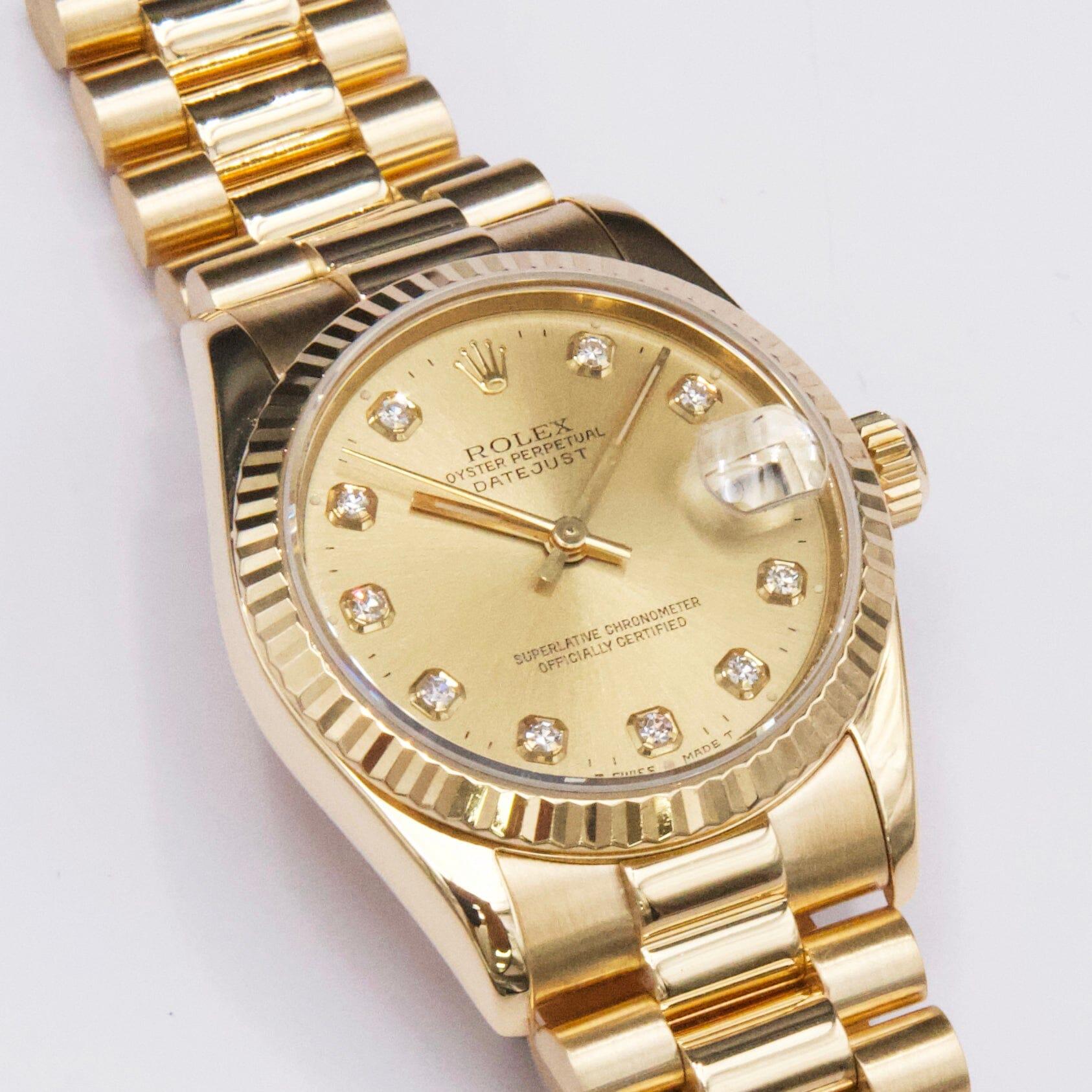 Rolex Oyster Perpetual Datejust 68278 Ladies Watch. 31mm 18k yellow gold case with 18K yellow gold fluted bezel. Champagne dial with gold hands and original factory diamond set hour marker. Date display at 3 o'clock position. 18K yellow gold