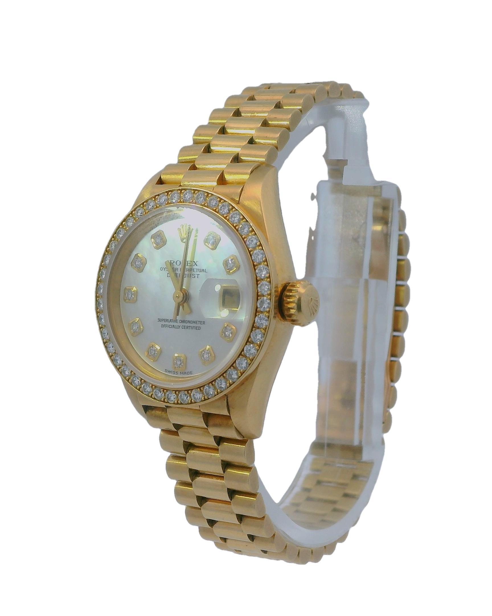 Rolex Datejust Ladies' Watch 69138. This exquisite timepiece features a 26mm case made of 18K yellow gold, complemented by an original factory diamond-set bezel. The mother-of-pearl dial showcases gold luminous hands and original factory diamond-set