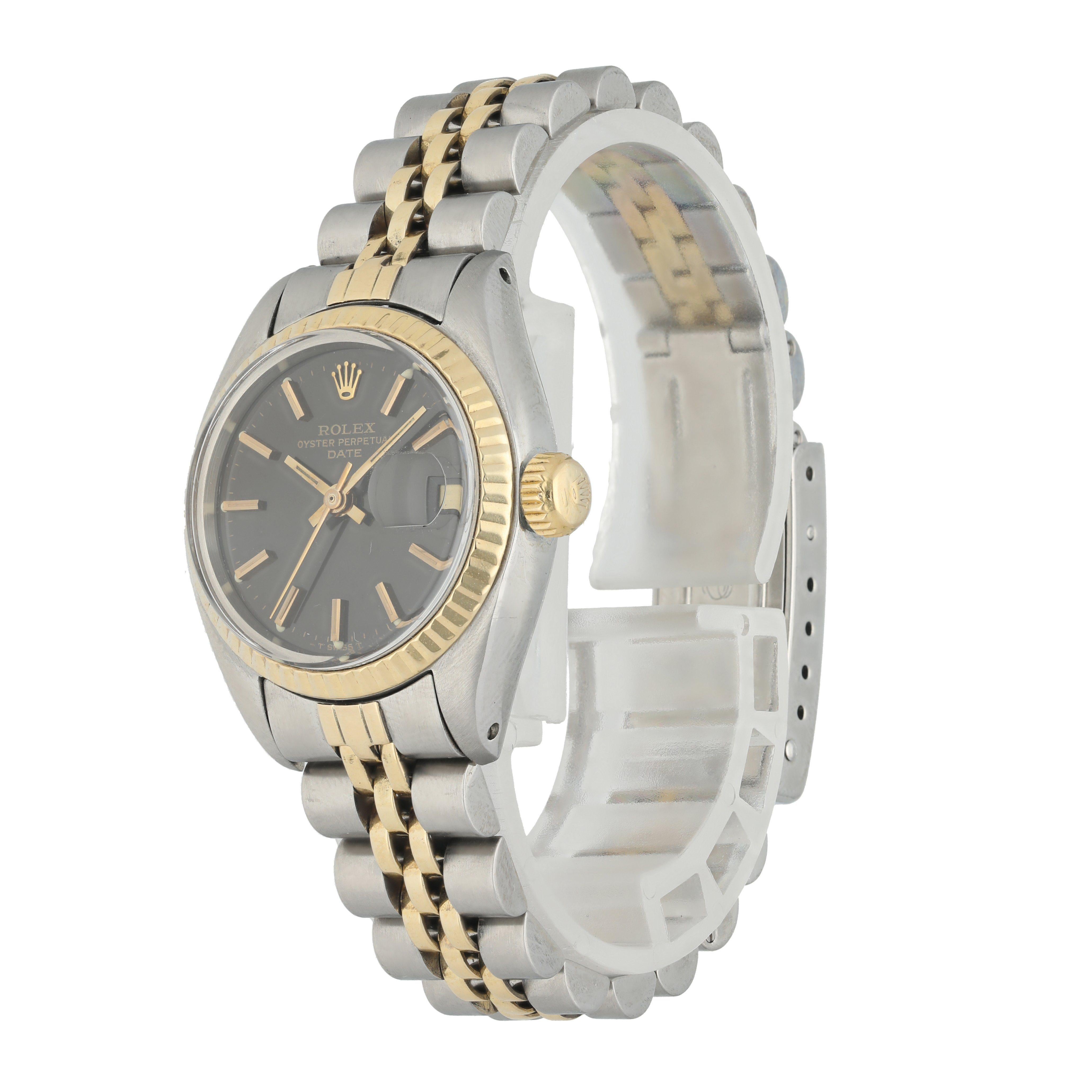 Rolex Datejust 6917 Ladies Watch. 
26mm Stainless Steel case. 
Yellow Gold fluted bezel. 
Black dial with luminous gold hands and Factory set diamond hour markers. 
Minute markers on the outer dial. 
Date display at the 3 o'clock position.