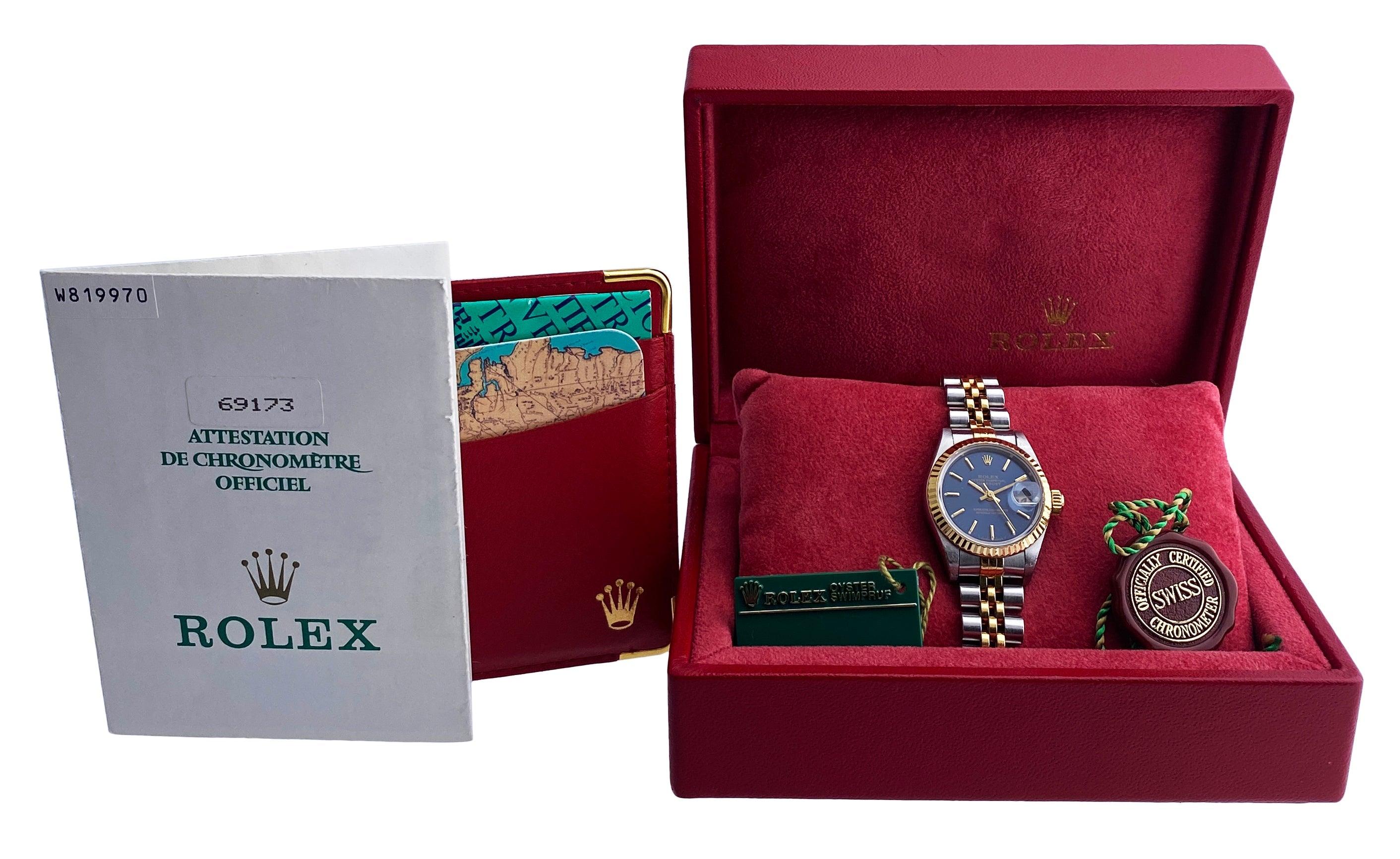 Rolex Datejust 69173 Ladies Watch. 26mm stainless steel case with 18K yellow gold fluted bezel. Blue dial with gold hands and index hour markers. Minute markers on the outer dial. Date display at the 3 o'clock position. Stainless steel & 18K yellow