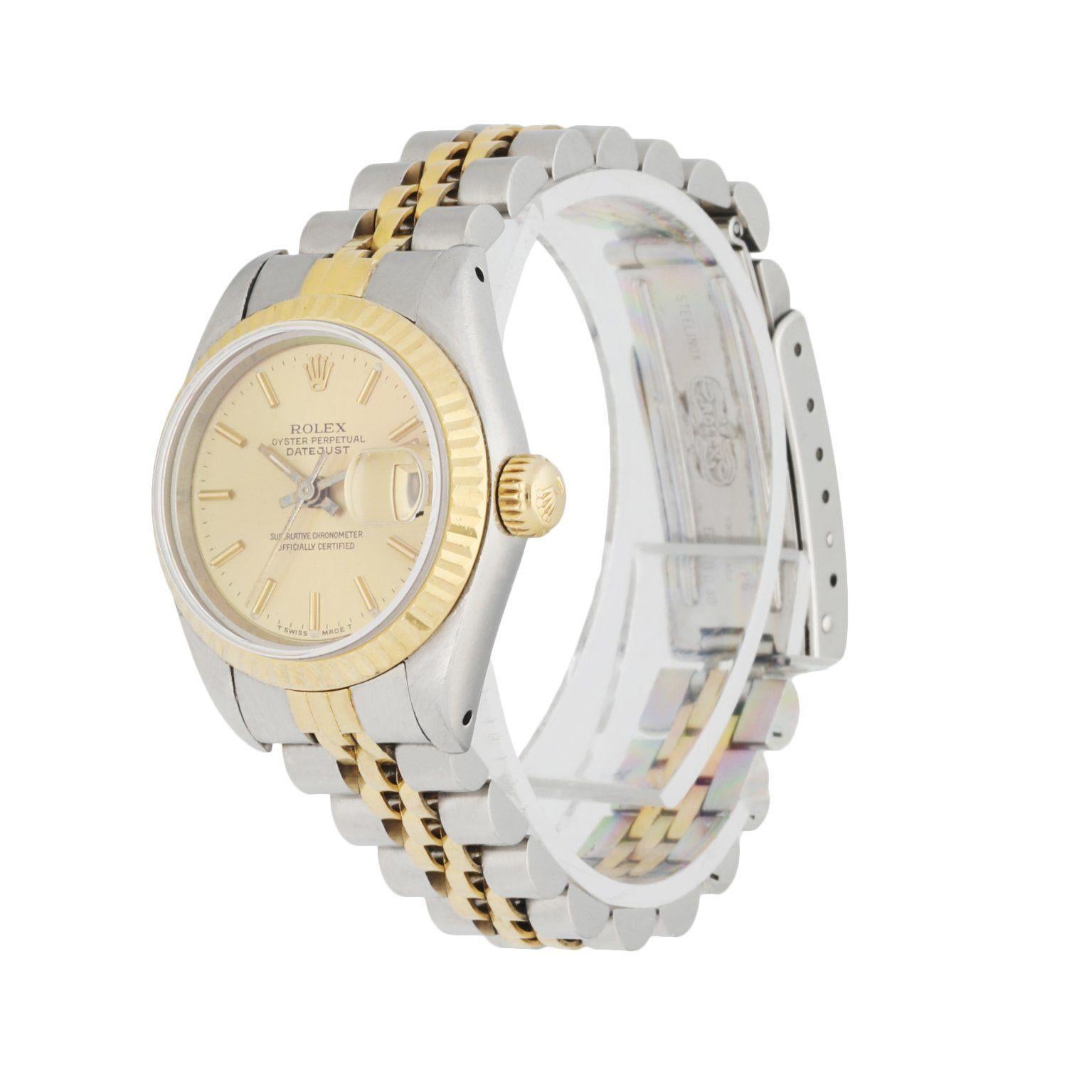 Rolex Datejust 69173 Ladies Watch. 26mm Stainless Steel case. 18K Yellow GoldÂ fluted bezel. Champagne dial with Luminous gold hands and index hour markers. Minute markers on the outer dial. Date display at the 3 o'clock position. Stainless steel &