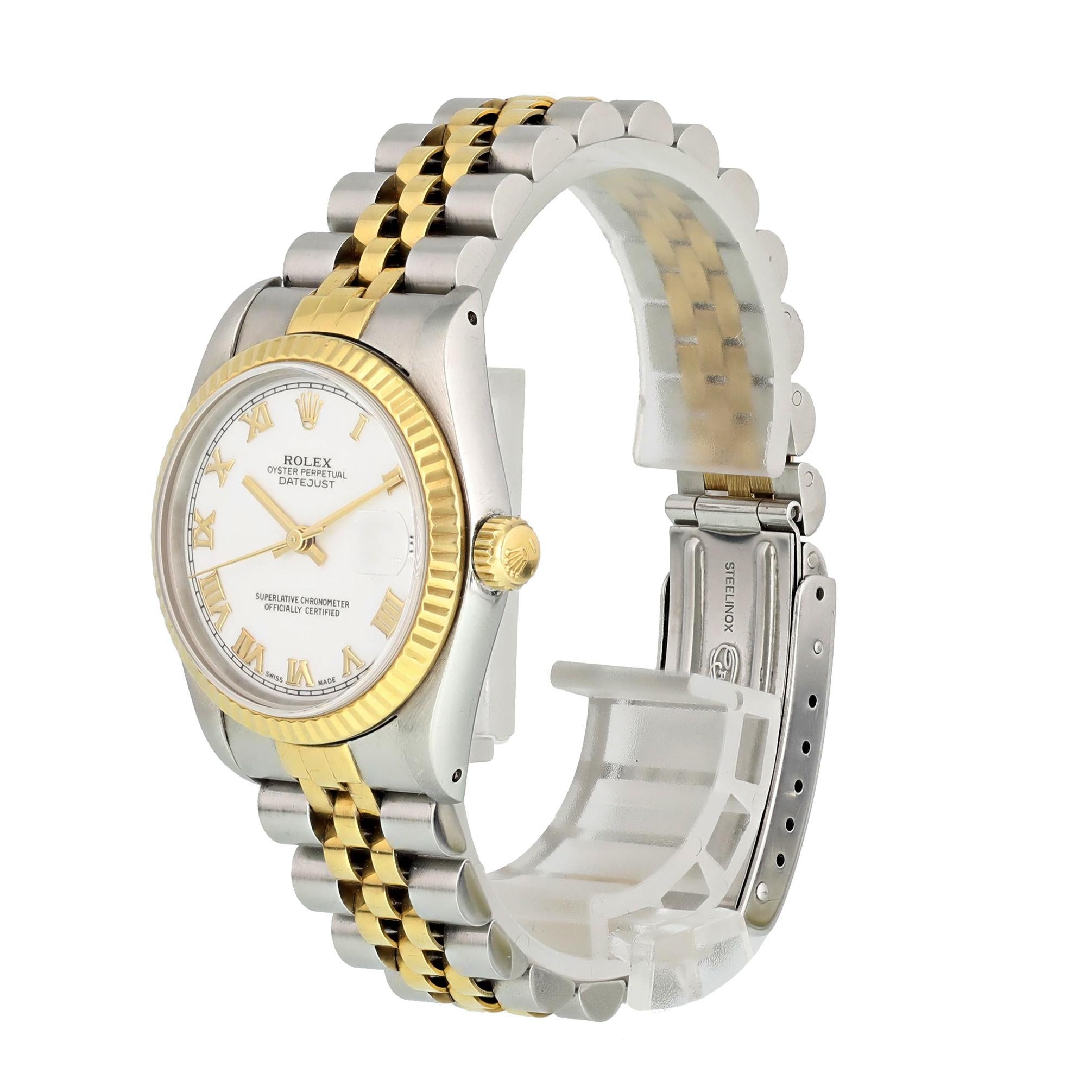 Rolex Datejust 69173 Ladies Watch
26mm Stainless Steel case. 
Yellow Gold Stationary bezel. 
White dial with gold hands and Roman numeral hour markers. 
Minute markers on the outer dial. 
Date display at the 3 o'clock position. 
Stainless Steel