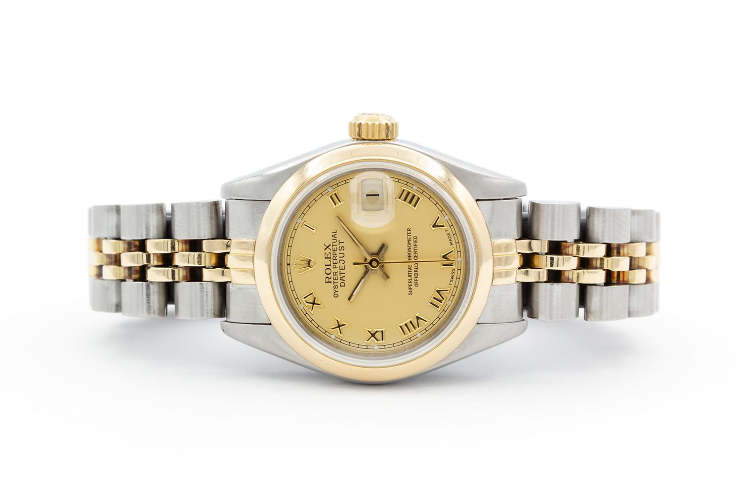 We are pleased to offer this 1987 Rolex Ladies Two Tone Datejust 69173. This is a classic ladies watch, timeless in its design. It features a 26mm stainless steel case, 18k yellow gold smooth bezel, champagne roman dial and two tone stainless steel