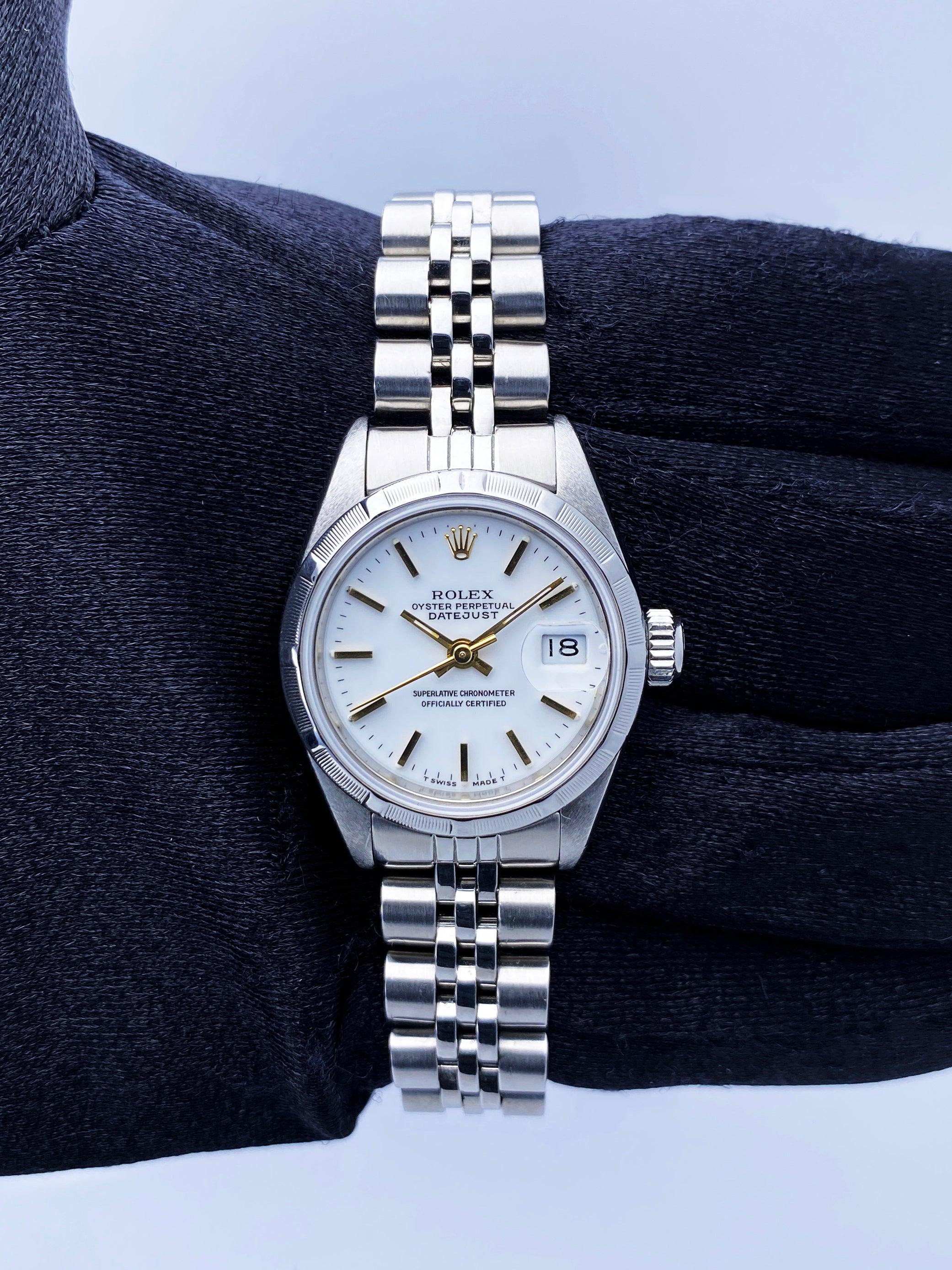 Rolex Oyster Perpetual Datejust 69190 Ladies Watch. 26mm stainless steel case with stainless steel bezel. White dial with gold hands and gold index hour marker. Quickset date display at 3 o'clock position. Stainless steel Jubilee bracelet with fold