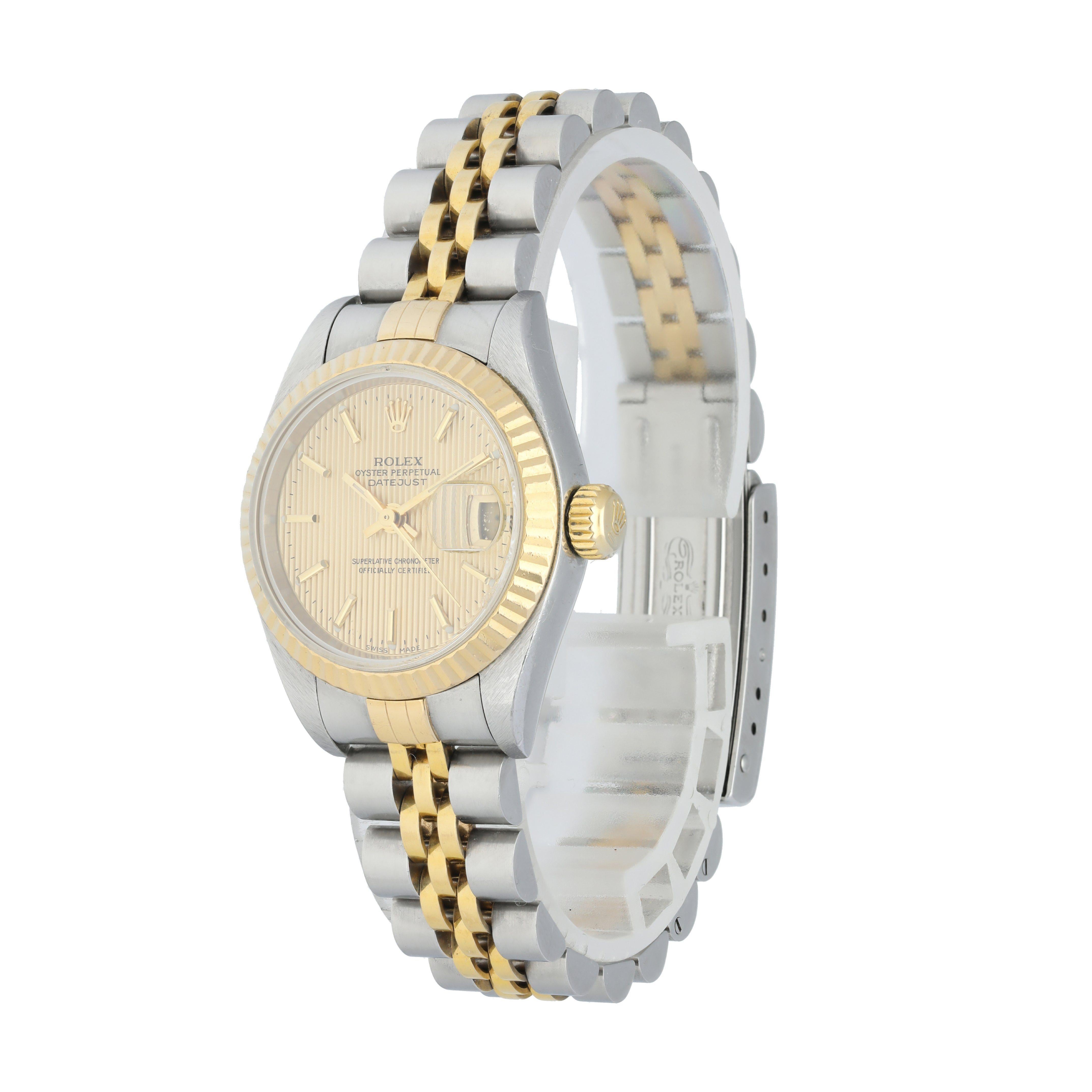 Rolex Datejust 79173 Tapestry Dial Ladies Watch.
26mm stainless steel case with yellow gold fluted bezel.
Champagne tapestry dial with luminous gold hands and index hour markers.
minute markers around the outer dial
Date display at the 3 o'clock