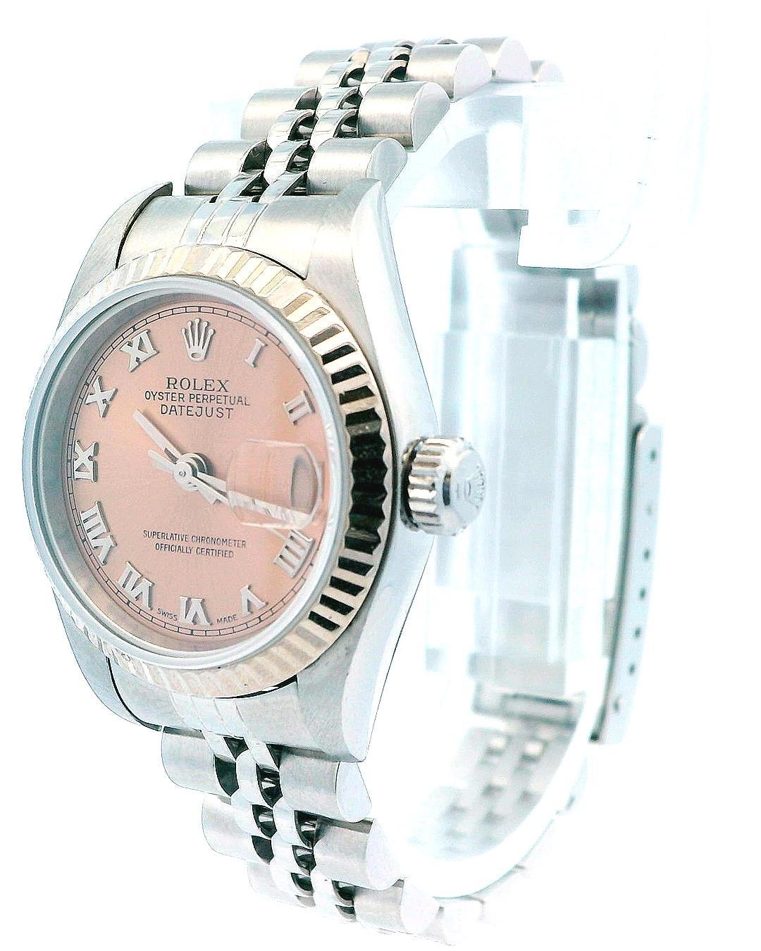 Rolex Datejust 79174 Ladies Watch. 26mm Stainless Steel case & 18K white gold stationary bezel. Pink dial with Steel hands and Roman numeral hour markers. Minute markers on the outer dial. Date display at the 3 o'clock position. Stainless Steel