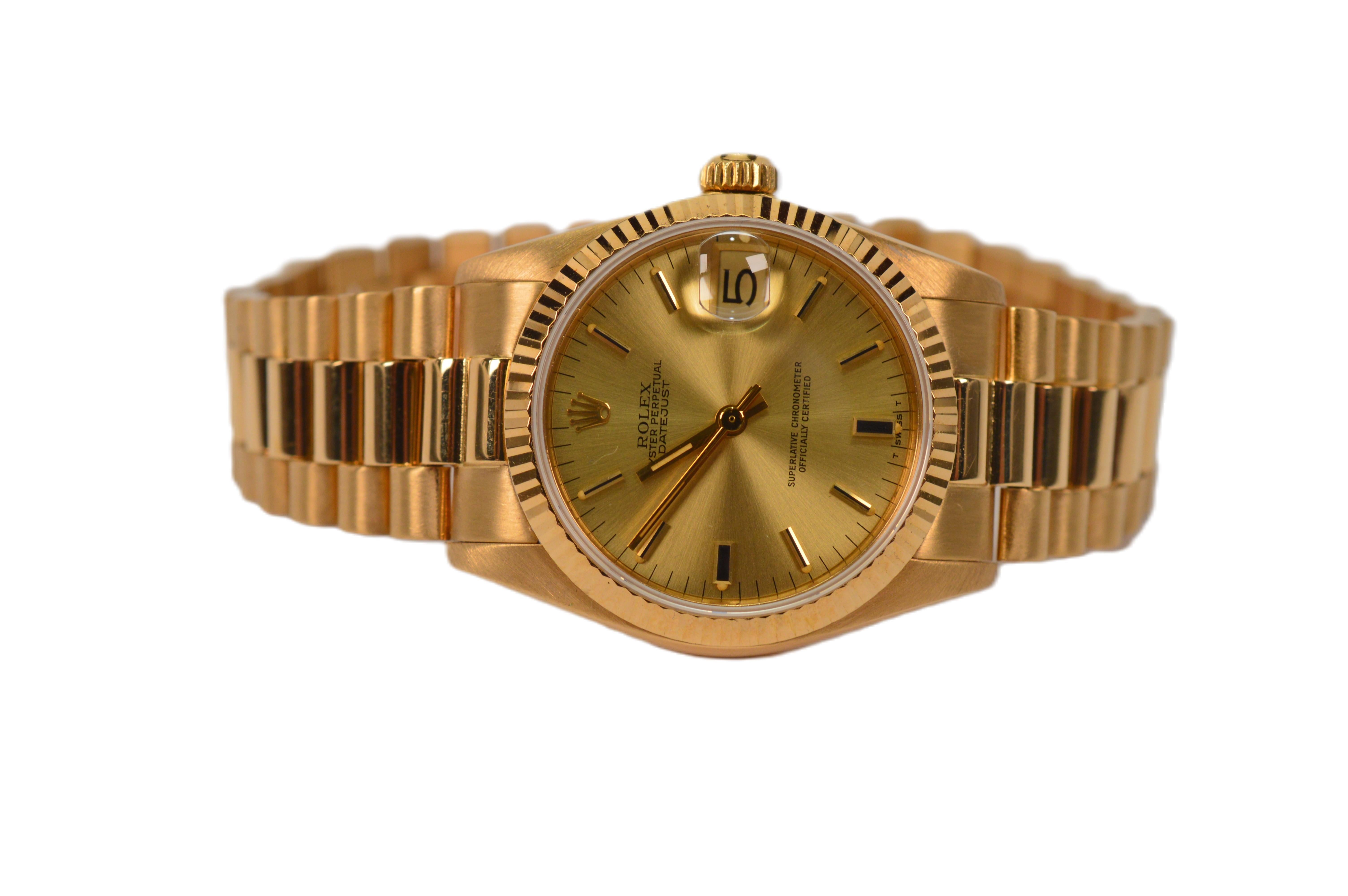 Magnificent Rolex Datejust Calibre 18 Karat Yellow Gold Watch with President bracelet.  Alternating satin gold and bright polish gold finishes throughout the watch lend sophisticated elegance to this popular Rolex timepiece.  The 28 jewel movement